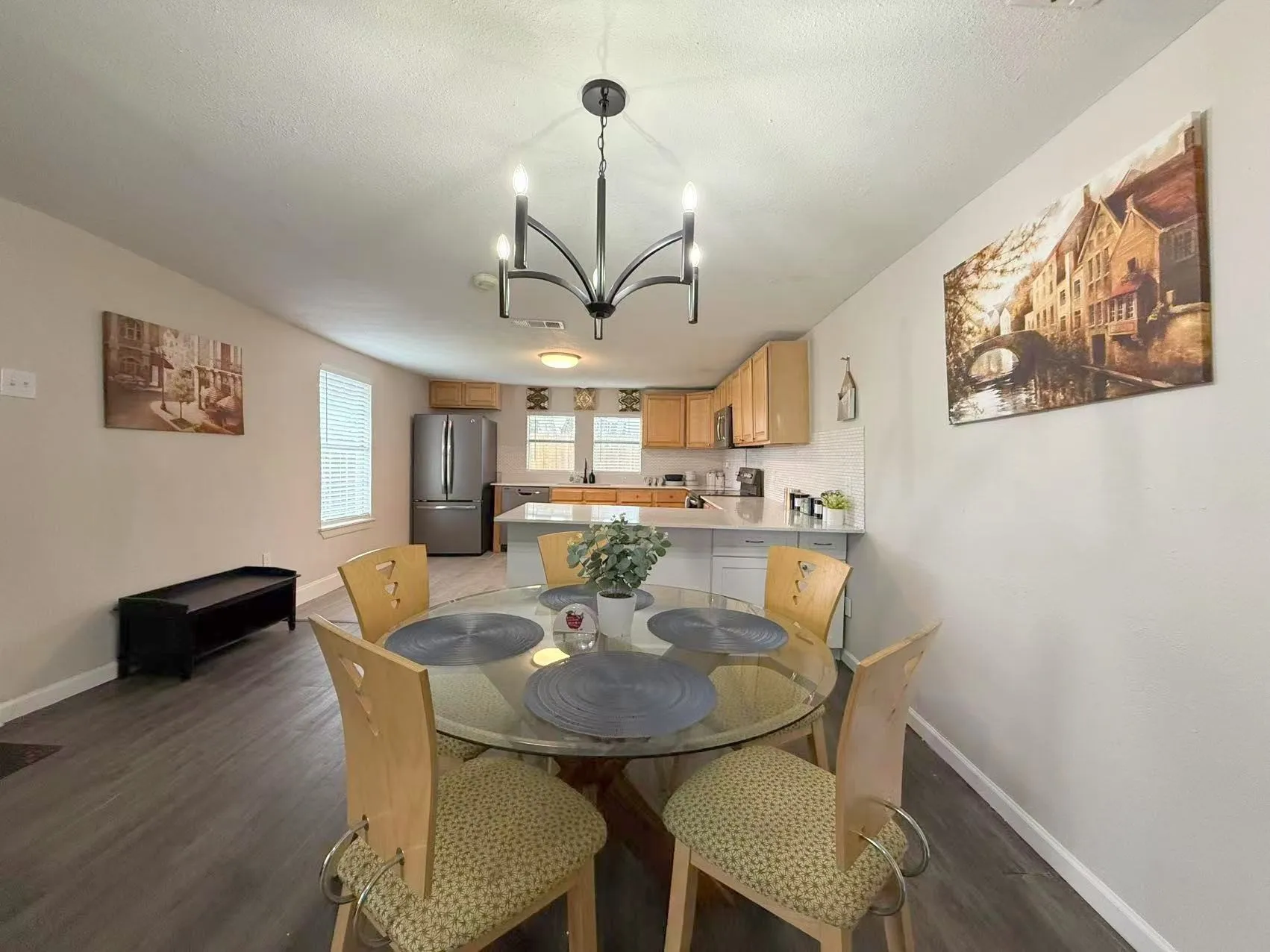 Open-concept kitchen and dining area with wood-finish flooring
