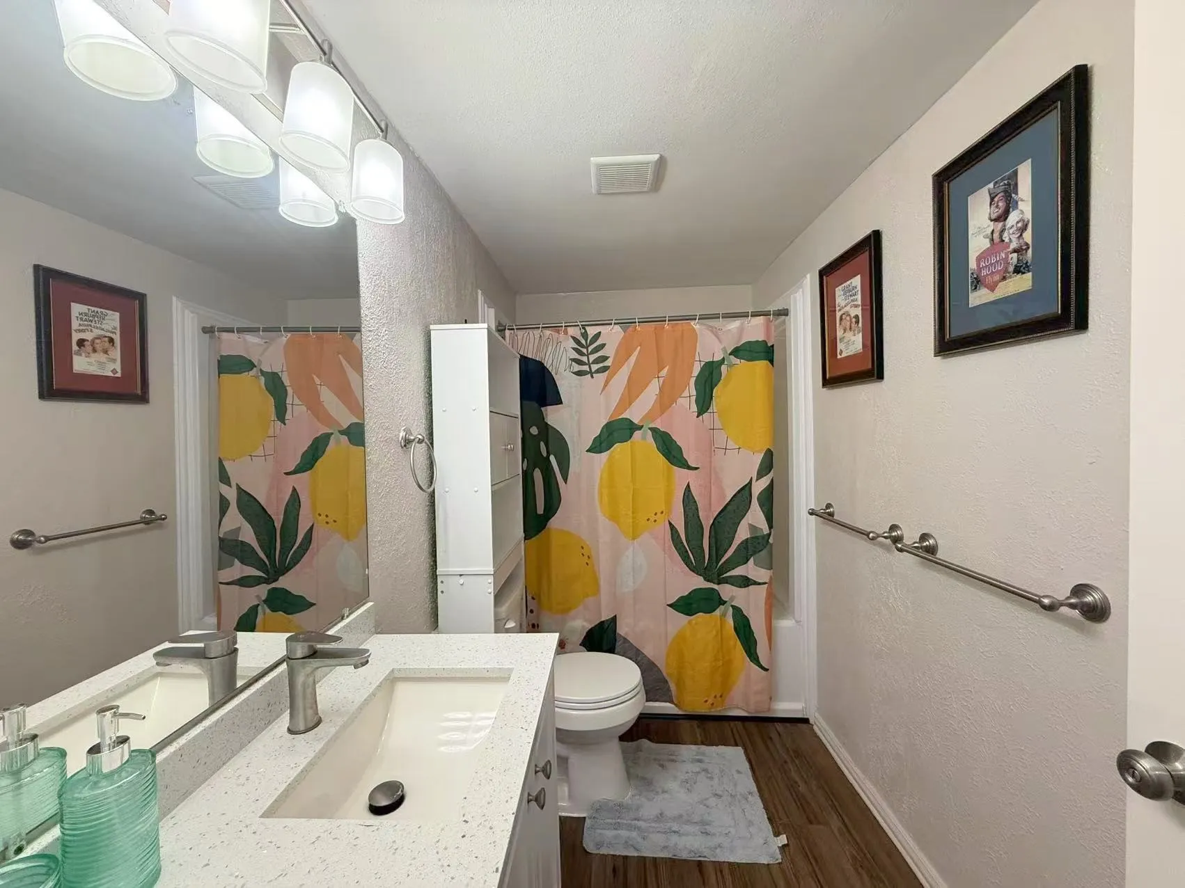 Bathroom featuring a single vanity with an integrated rectangular sink and a stainless steel faucet