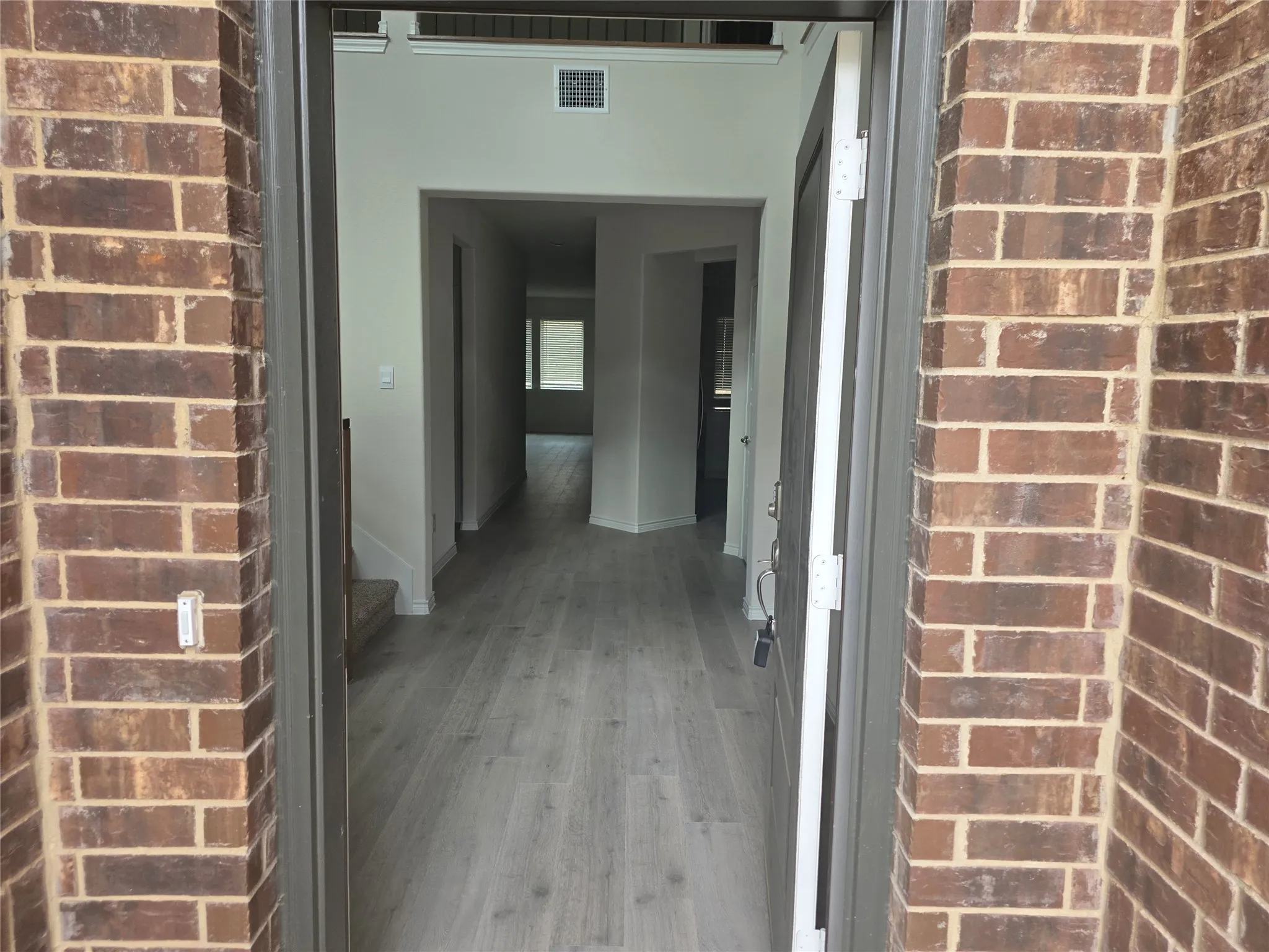 Brick exterior framing the entry