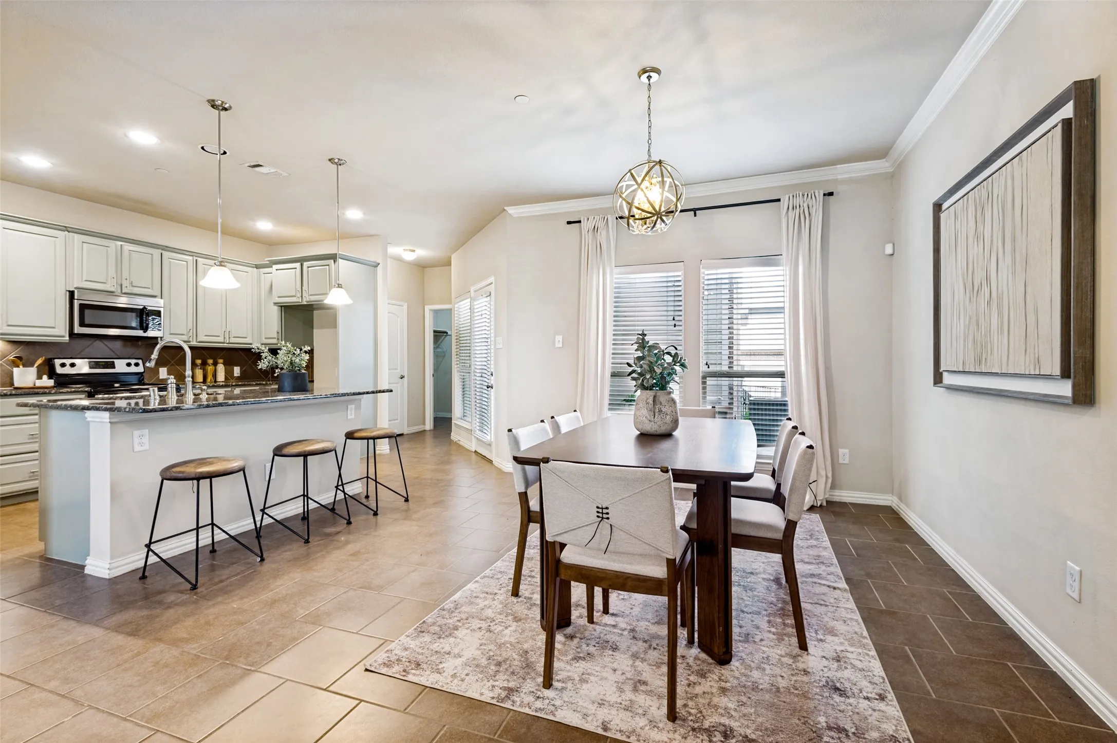 Dedicated dining space overlooking the patio with an open connection to the kitchen and living room