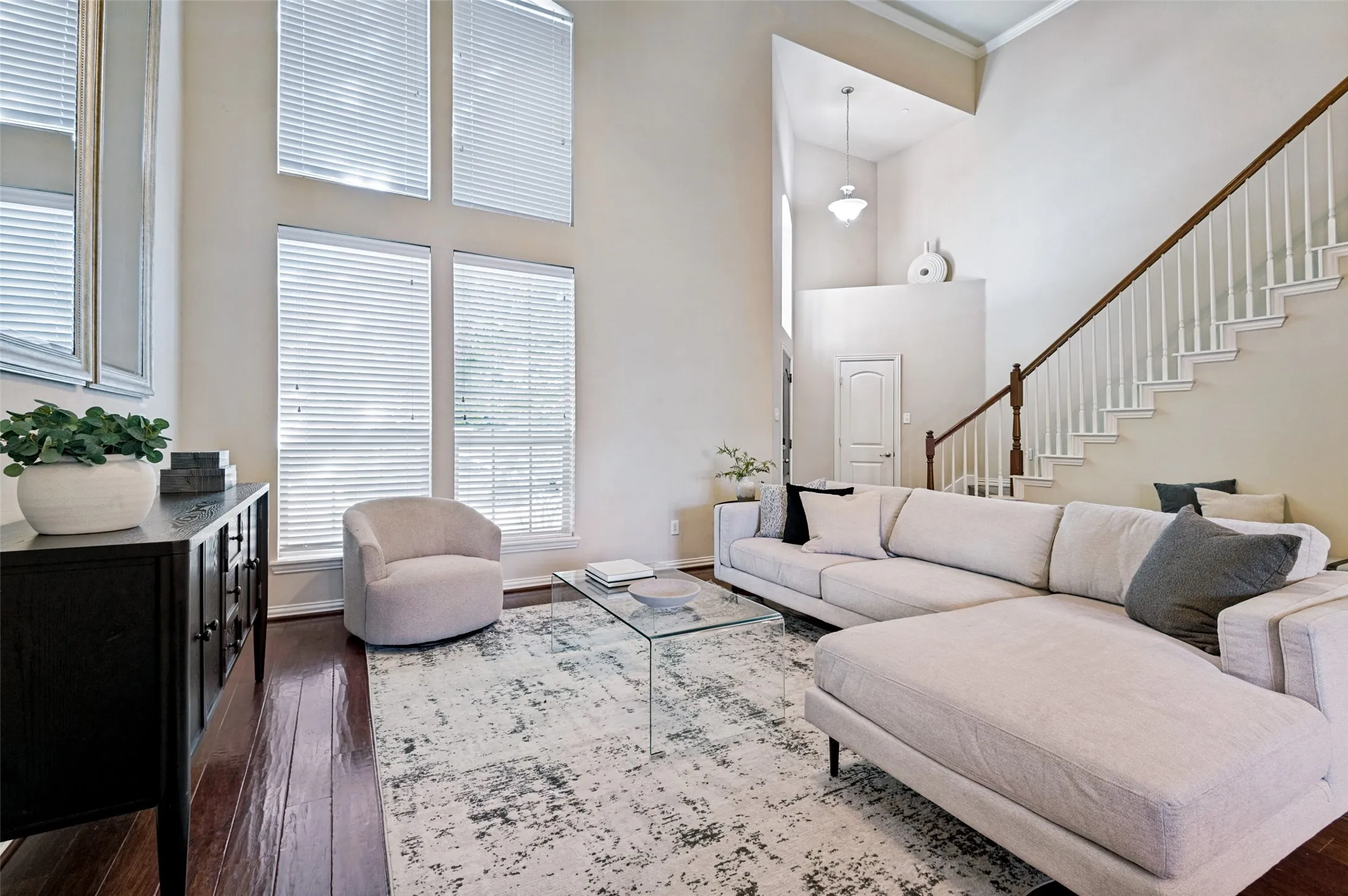 Expansive windows fill the large living room with natural light and emphasize the home's impressive vertical space.