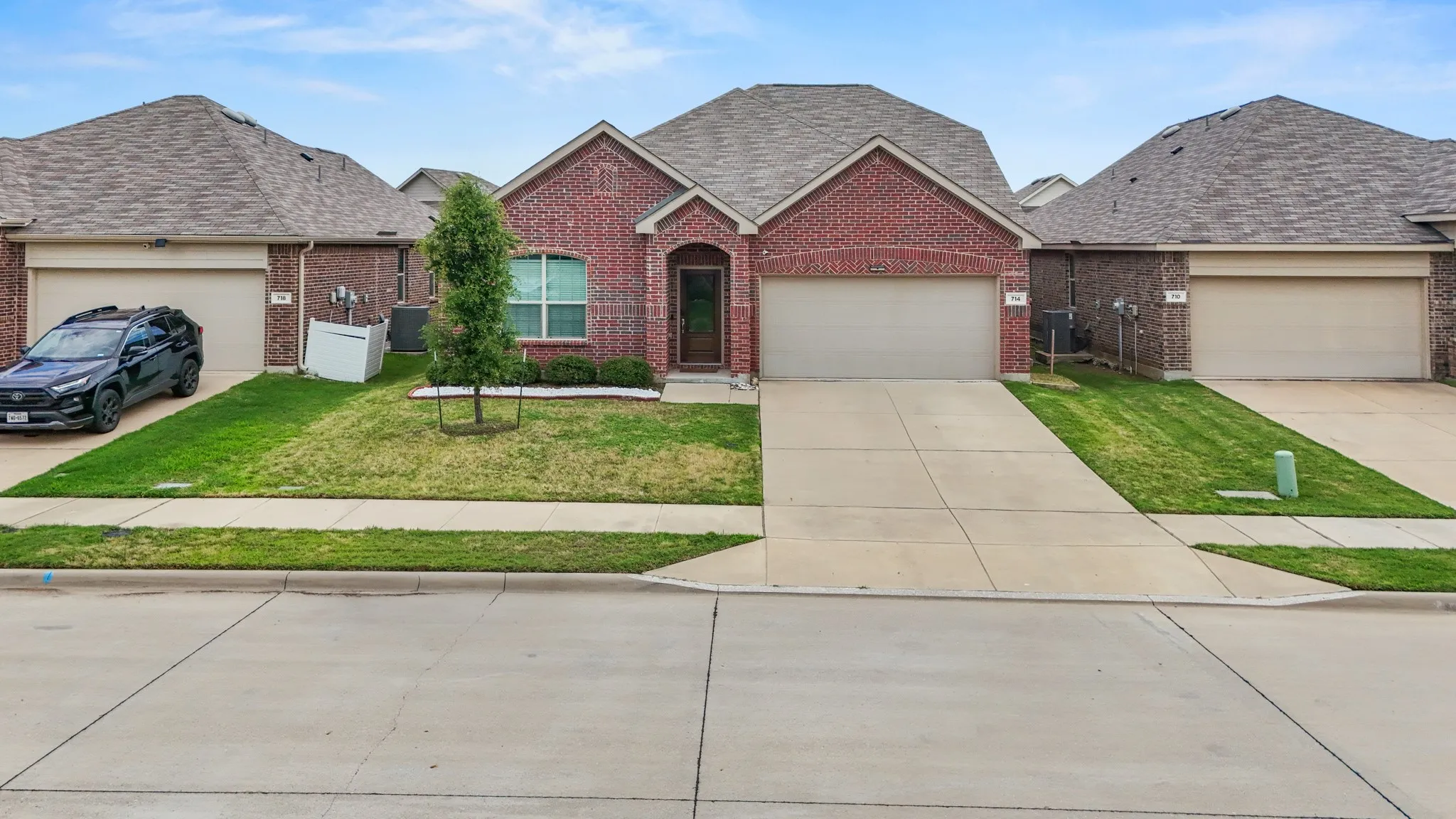 Traditional brick exterior with a gabled roofline and attached two-car garage