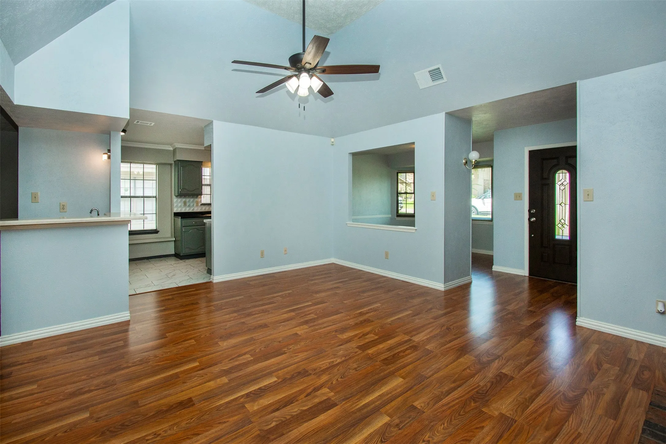 Vaulted ceiling interior with wood-finish flooring