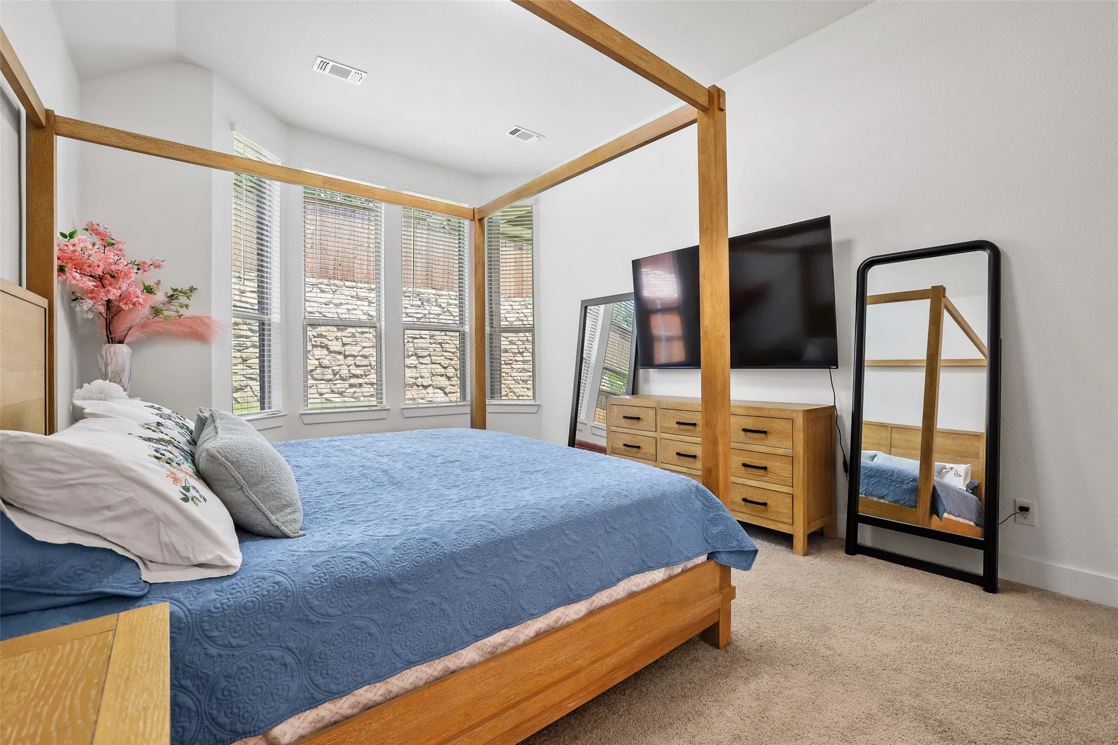 Large bay windows fill the primary bedroom with light