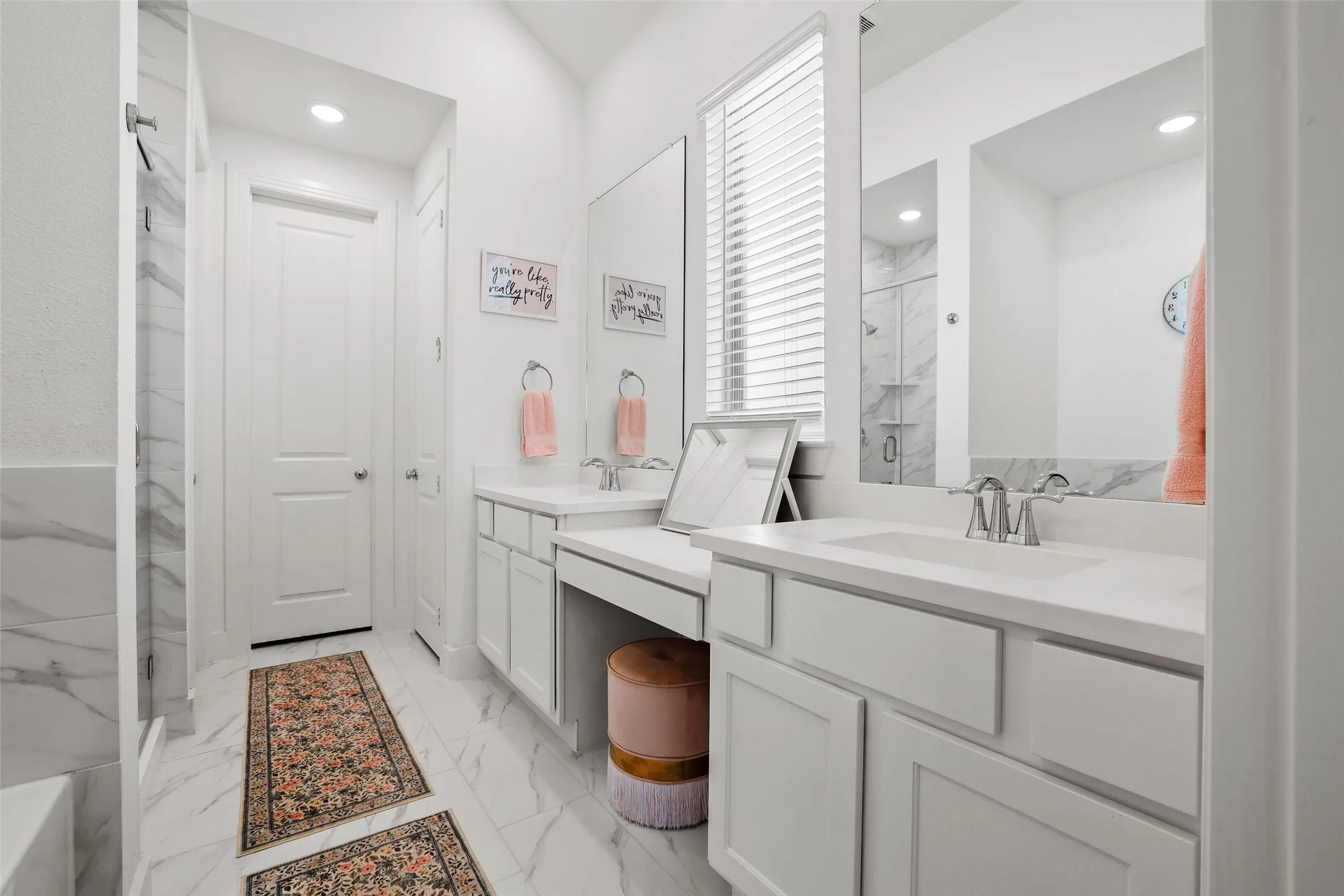 Primary bathroom with separate vanities and makeready area