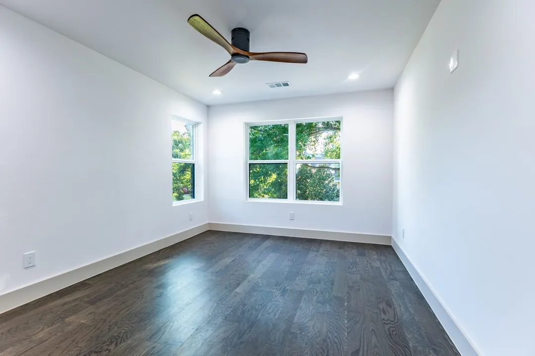 Room featuring dark wood-finish flooring, white walls, and white trim