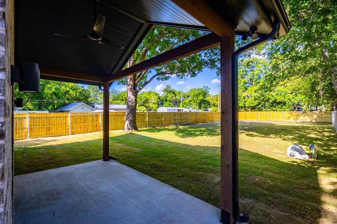 covered patio with tongue and groove ceiling with fan for outdoor living and easy grilling