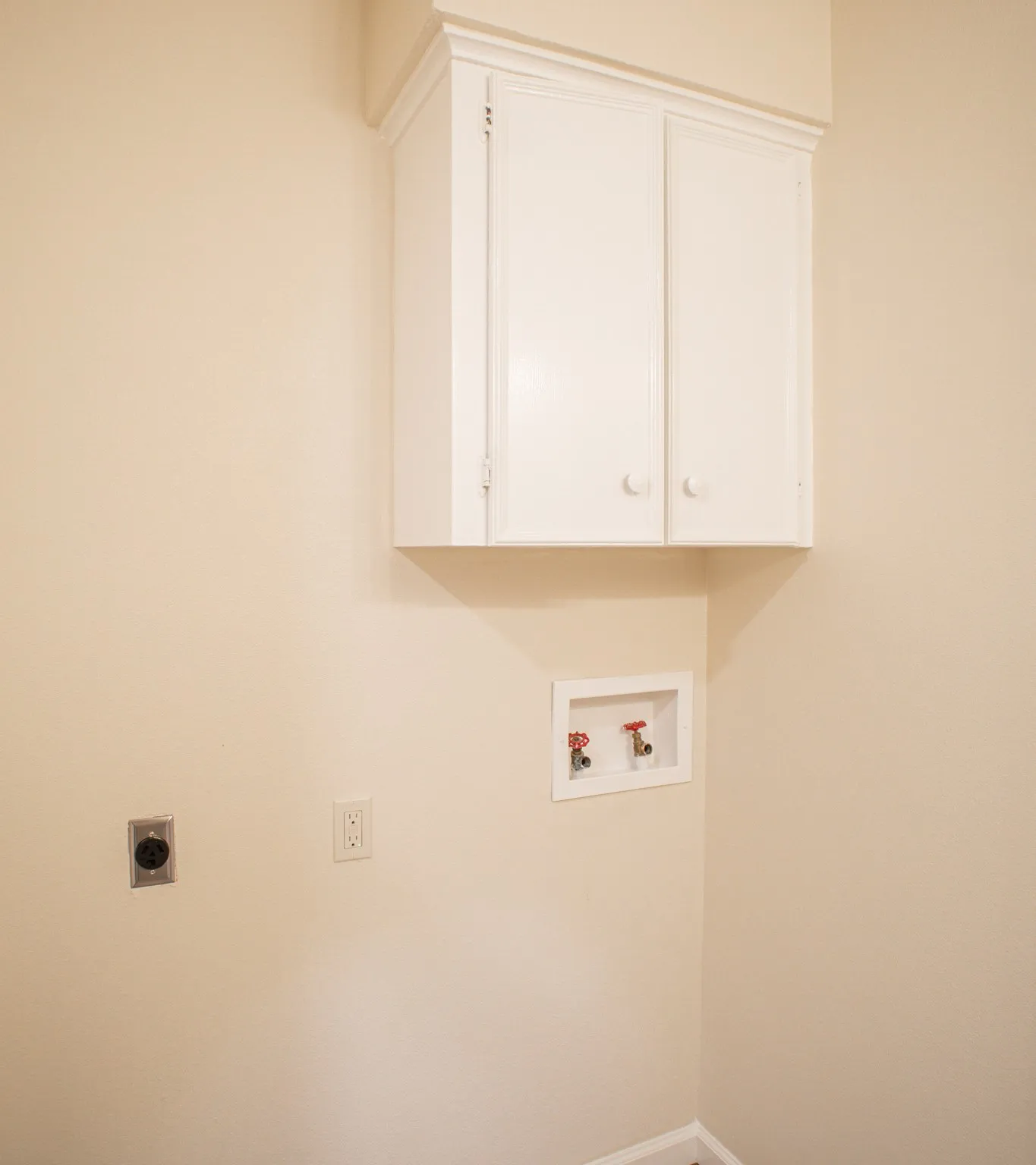 White upper cabinetry with crown molding details