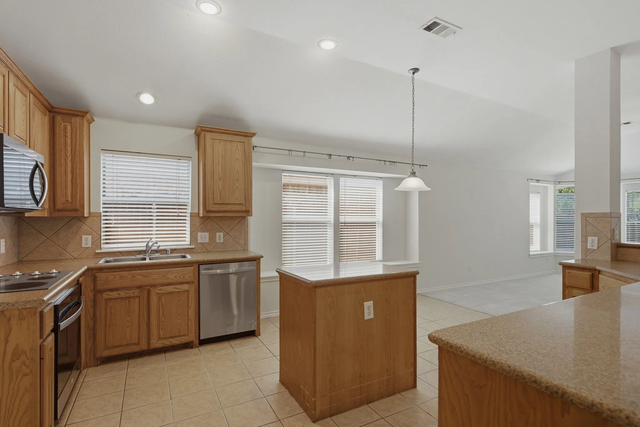 Kitchen featuring light wood cabinetry and stainless steel appliances.