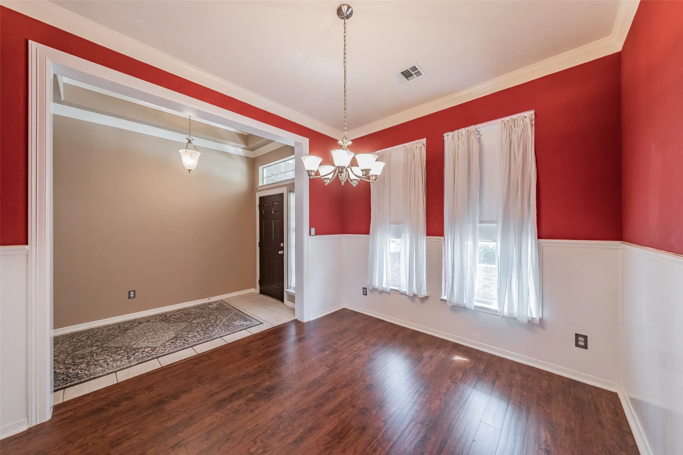 Formal dining room with crown molding, chair-rail detail and easy access to the kitchen.