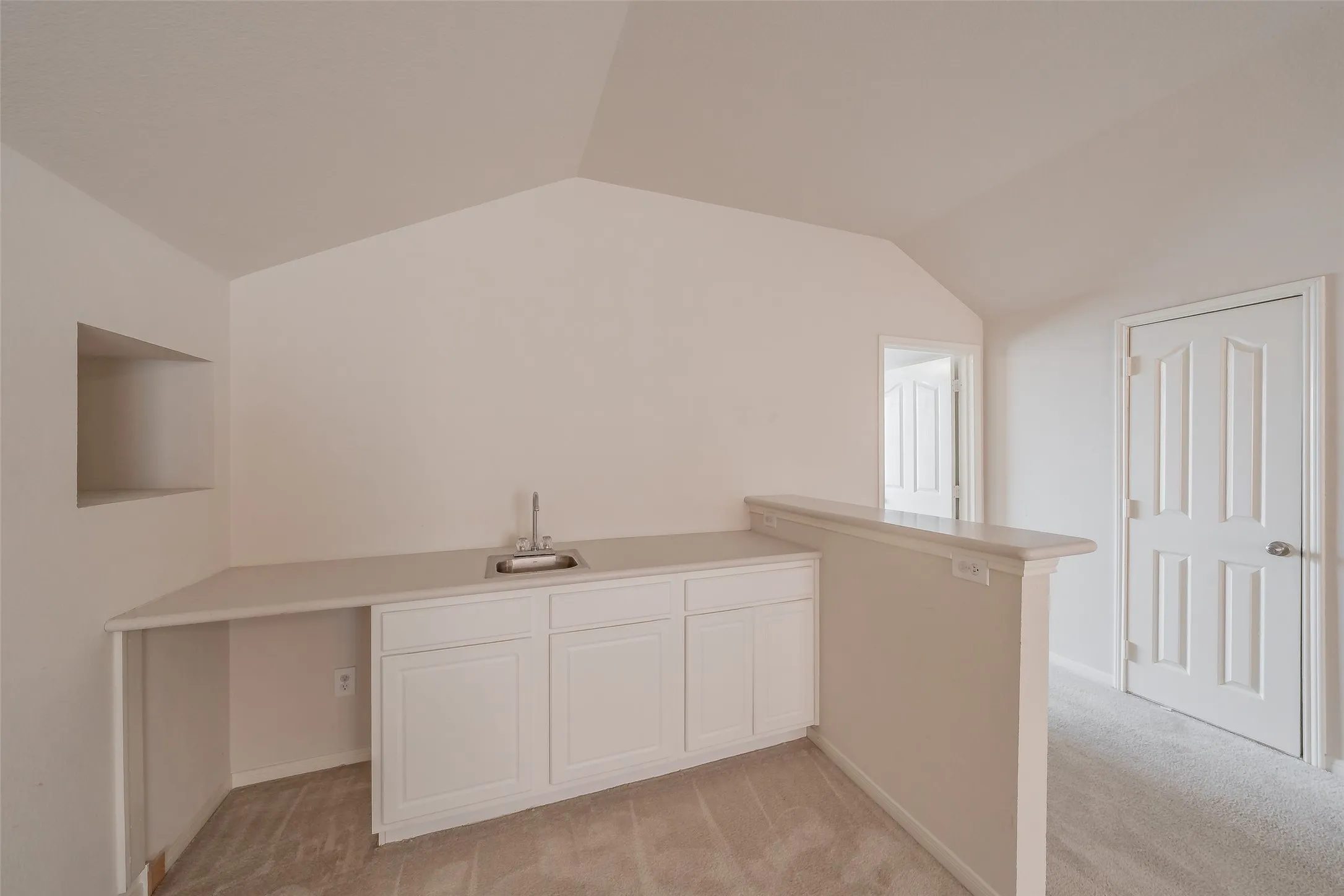 Upstairs wet bar with sink, cabinetry and counter space—ideal for entertaining in the adjacent game room.