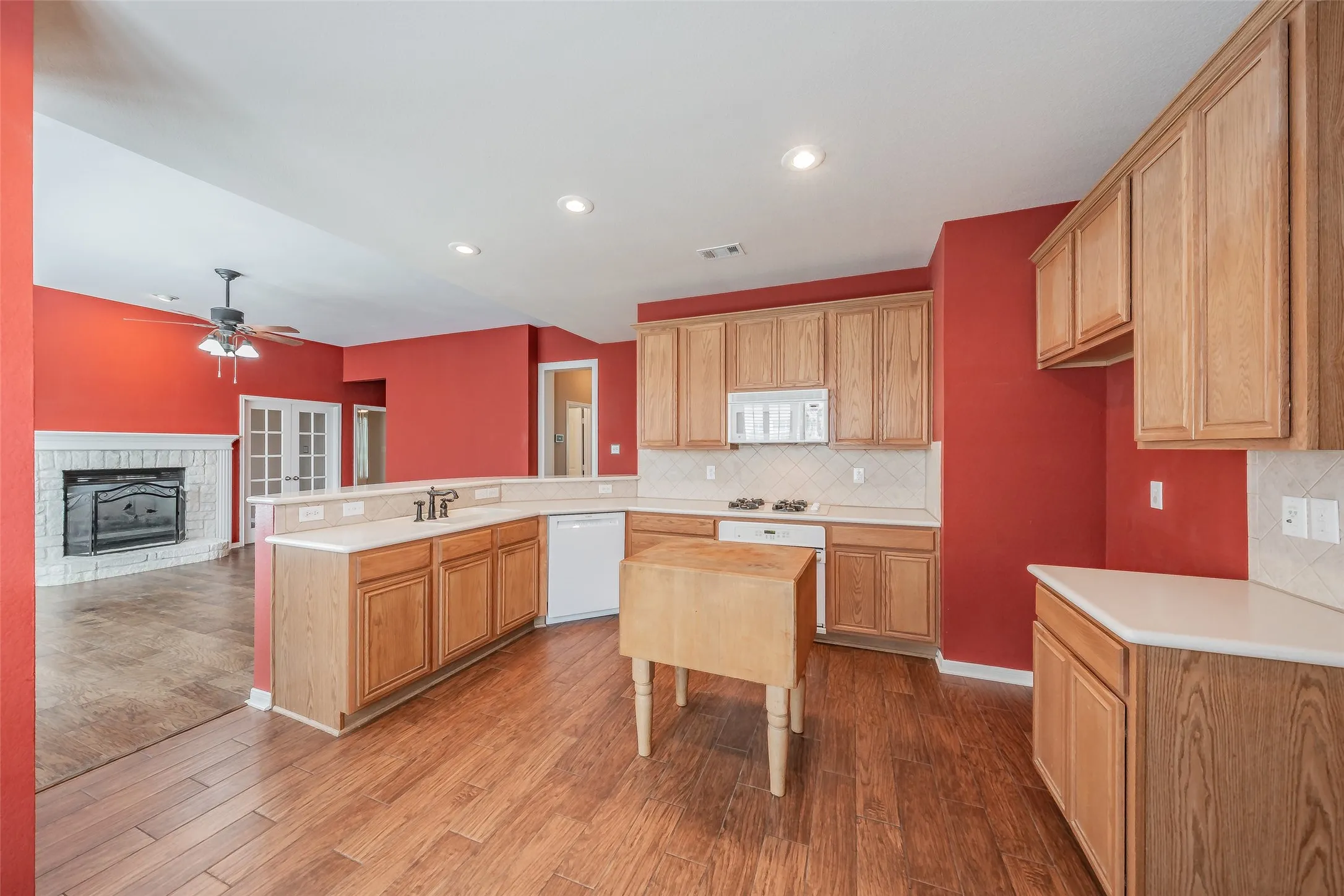 Spacious kitchen with abundant cabinetry, generous counter space and an open view into the living area.