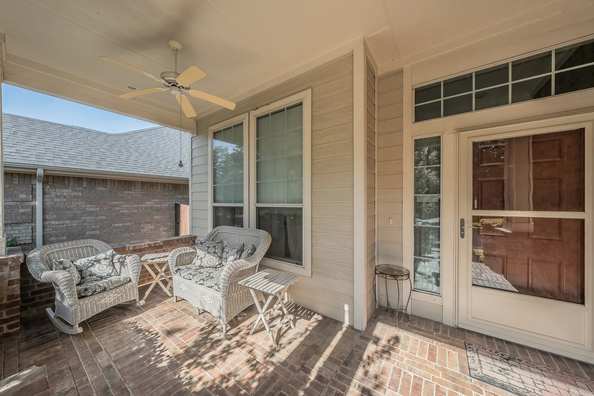 Covered front porch offers a shaded outdoor seating area and a welcoming approach to the home.