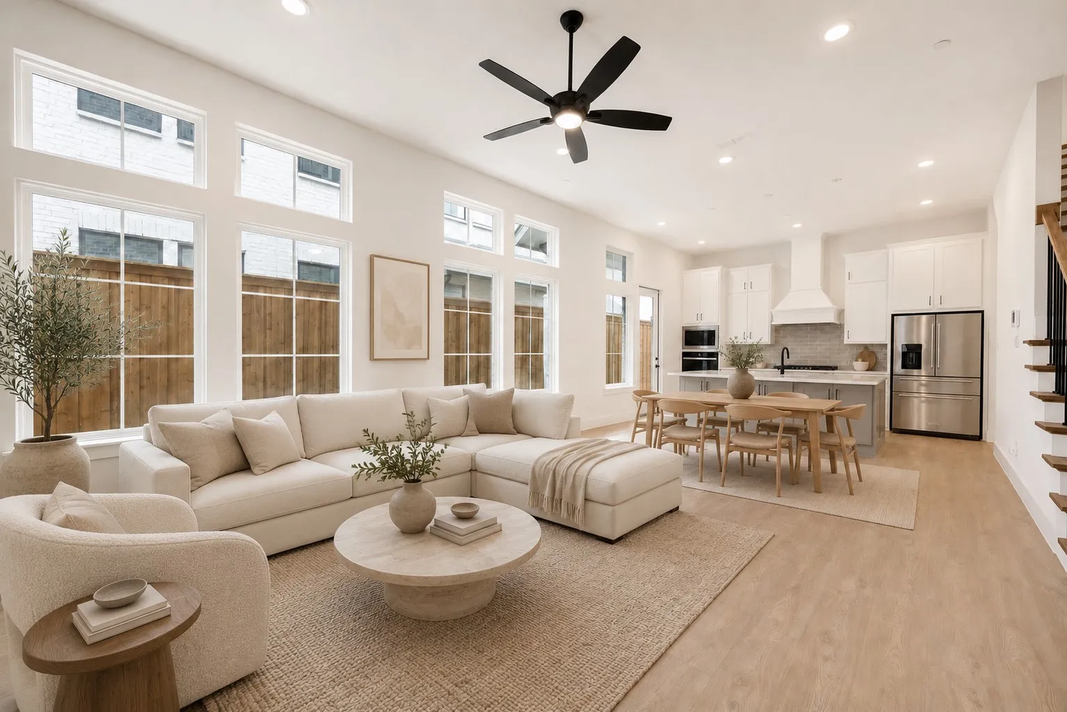 Open-concept living space featuring high ceilings, recessed lighting, and light wood-finish flooring