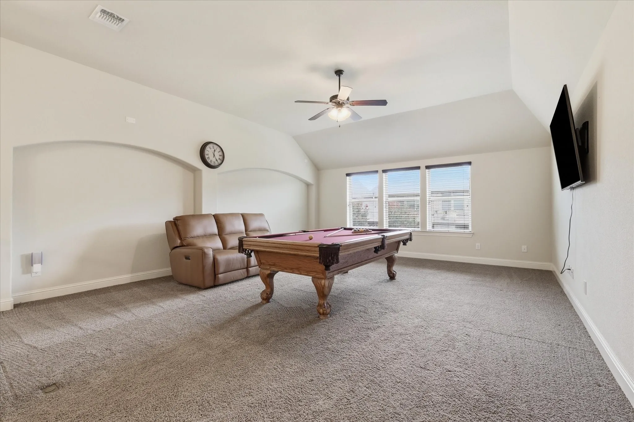 Spacious upstairs game room offering plenty of room for a pool table, media aream and additional seating.