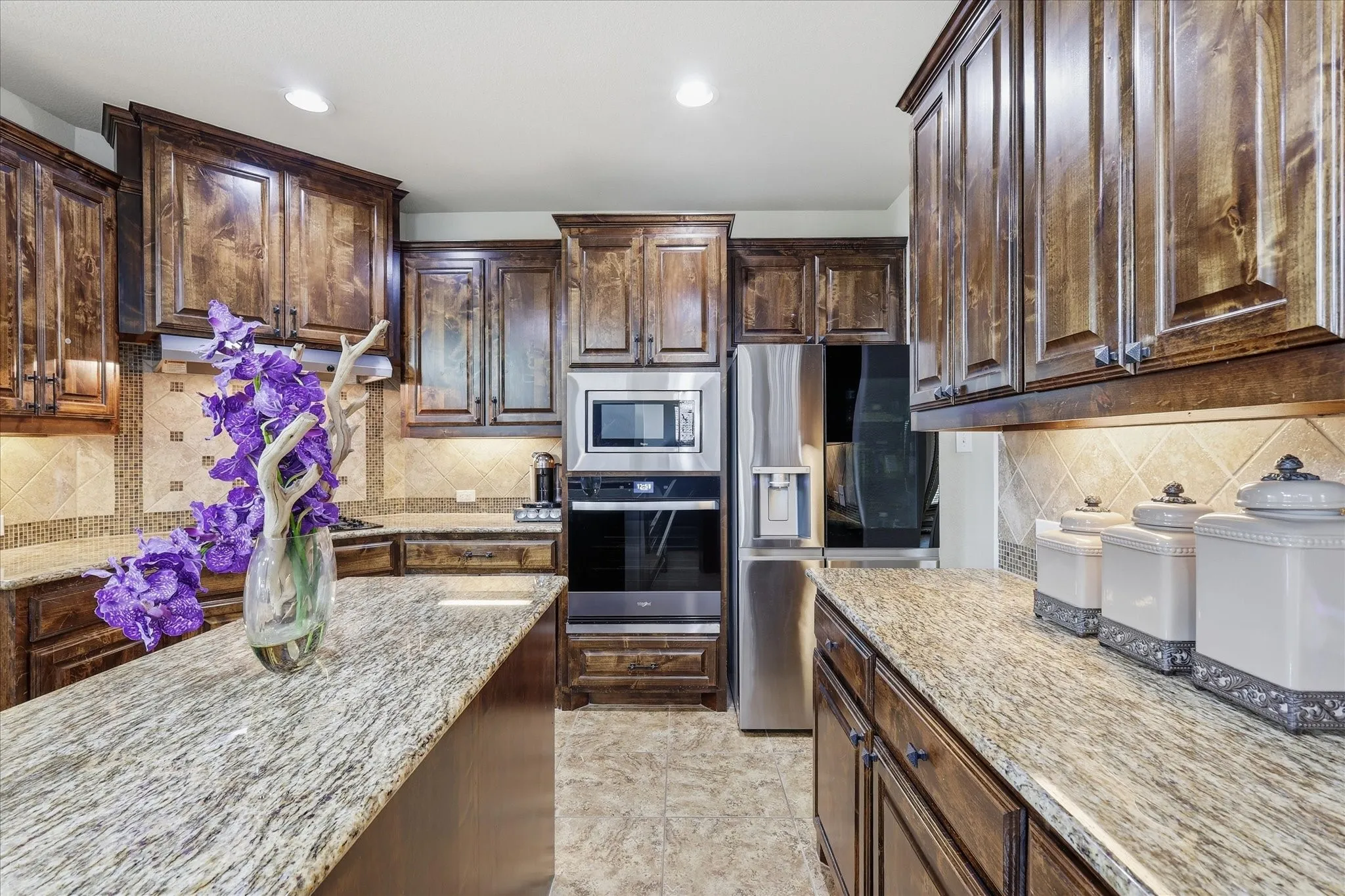 Stainless steel appliances—including a built-in oven, microwave, dishwasher and gas cooktop.