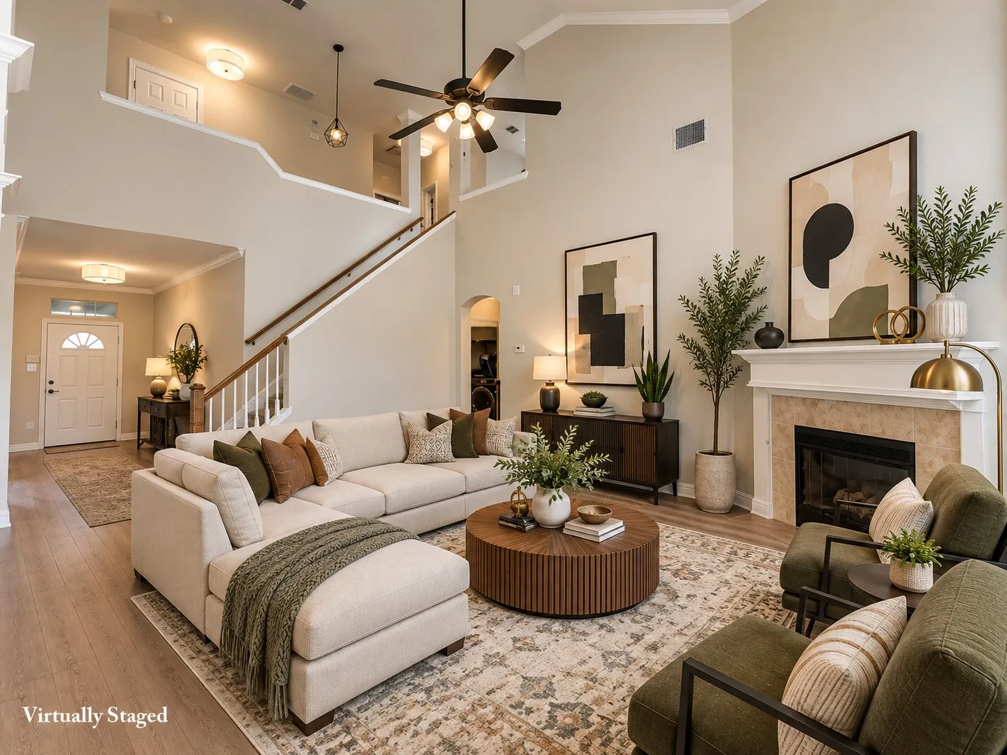 Two-story living area featuring a fireplace with a stone surround, a wood mantle, wood-finish flooring, and a ceiling fan