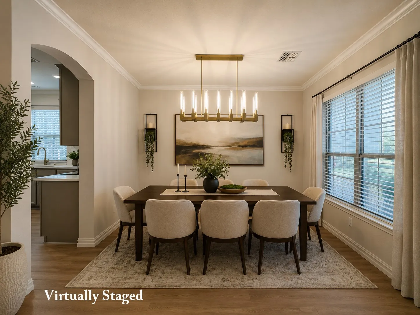 Dining area featuring wood-finish flooring, a large window with blinds, and an arched entryway