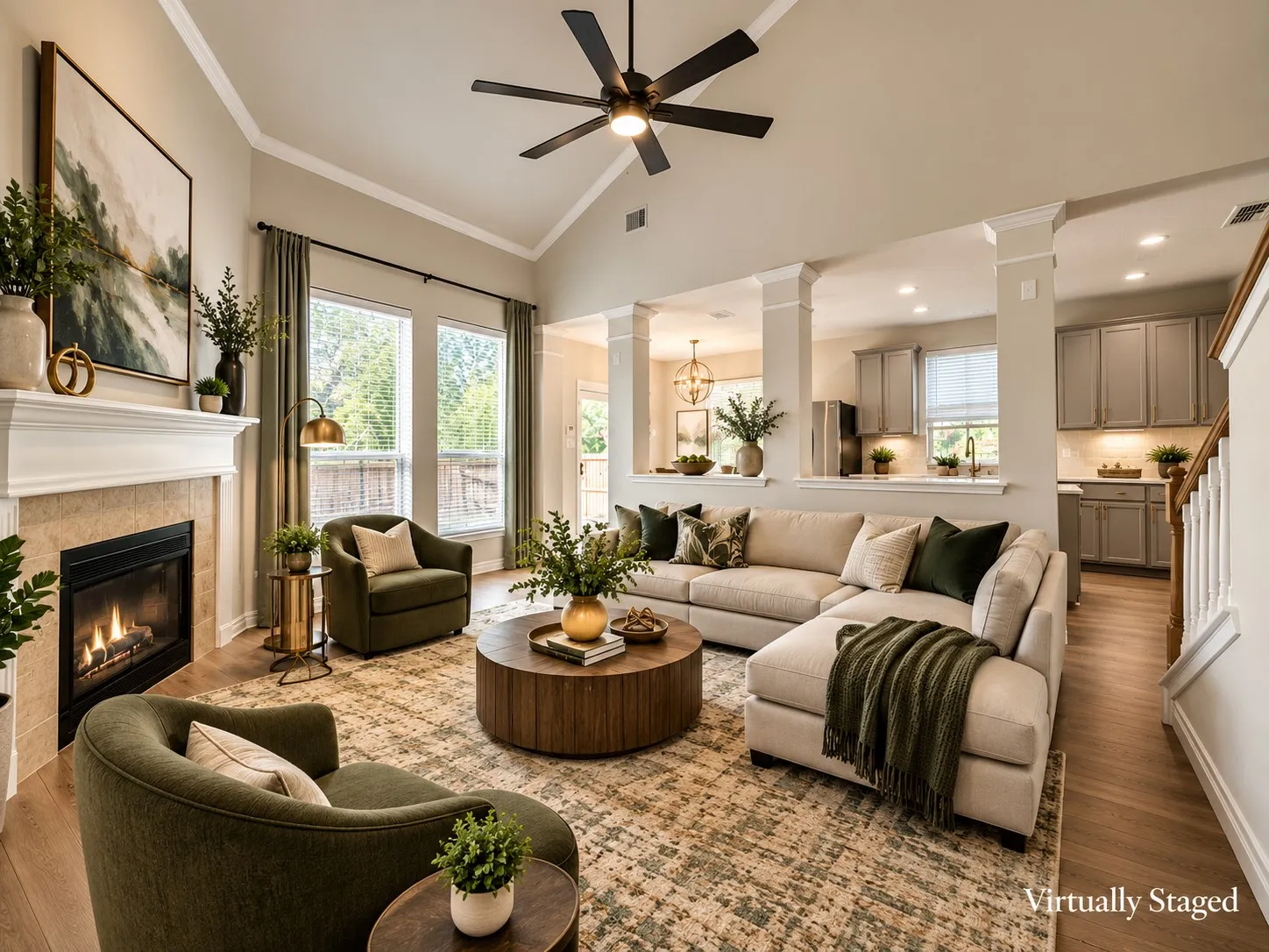 Vaulted ceiling with crown molding, wood-finish flooring, fireplace with a tile surround and mantel, and multiple large windows