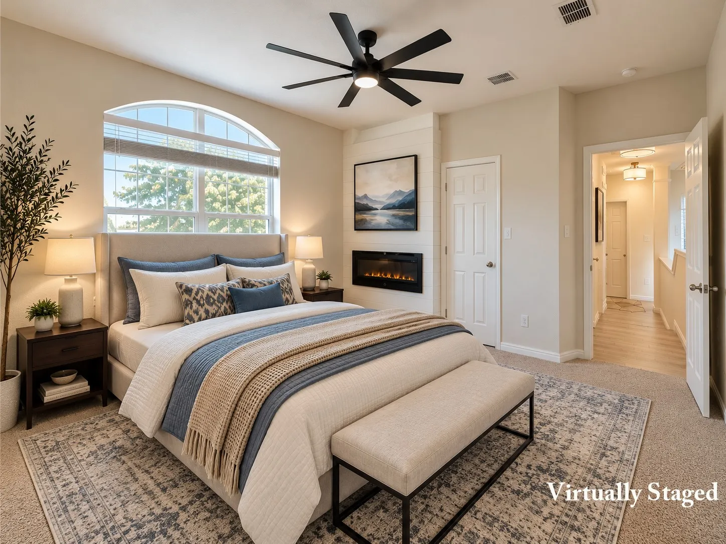 Arched window with blinds, ceiling fan, carpeted flooring, wall-mounted electric fireplace, and interior door