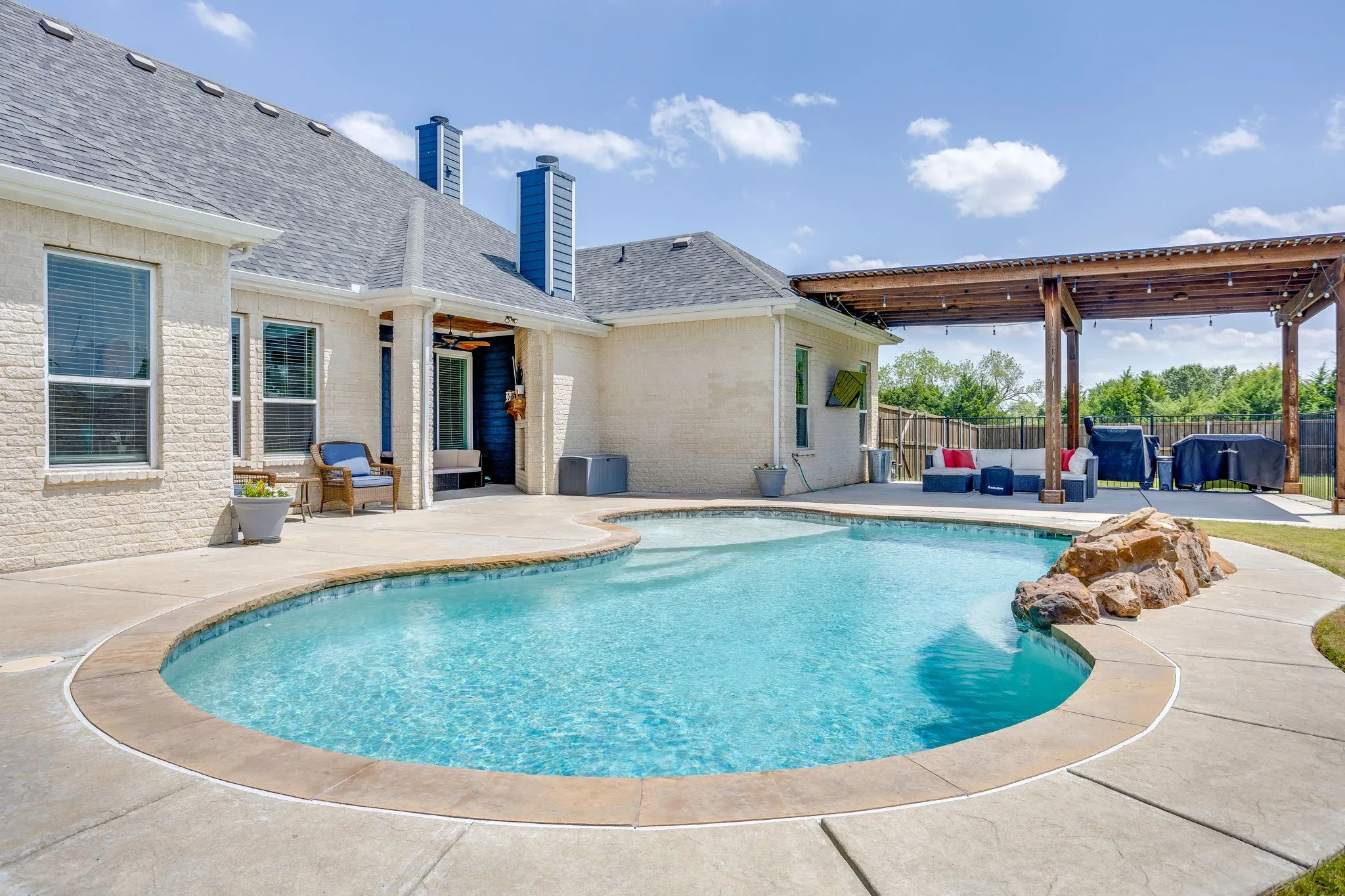 Freeform saltwater pool with rock waterfall