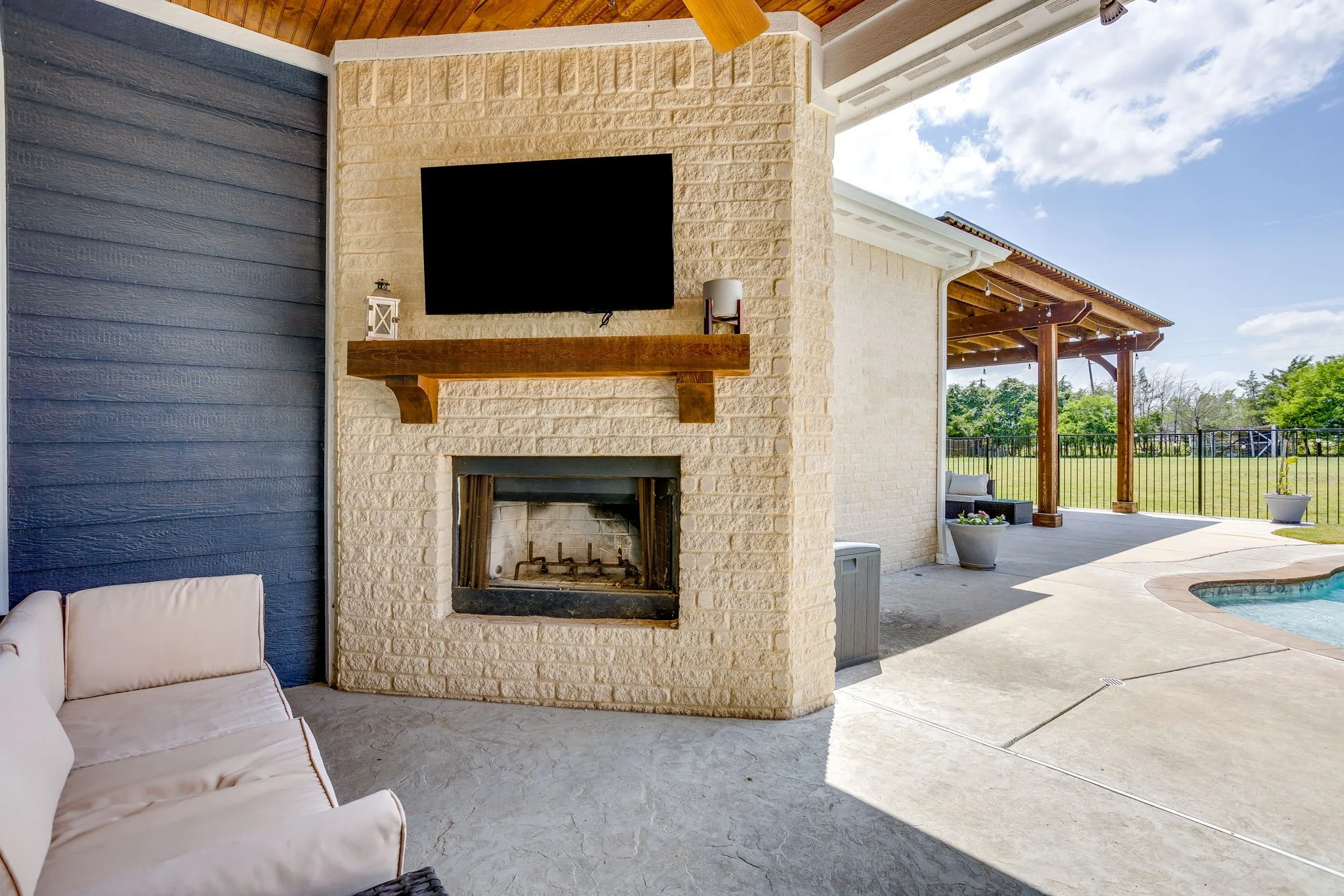 Covered patio with stone fireplace