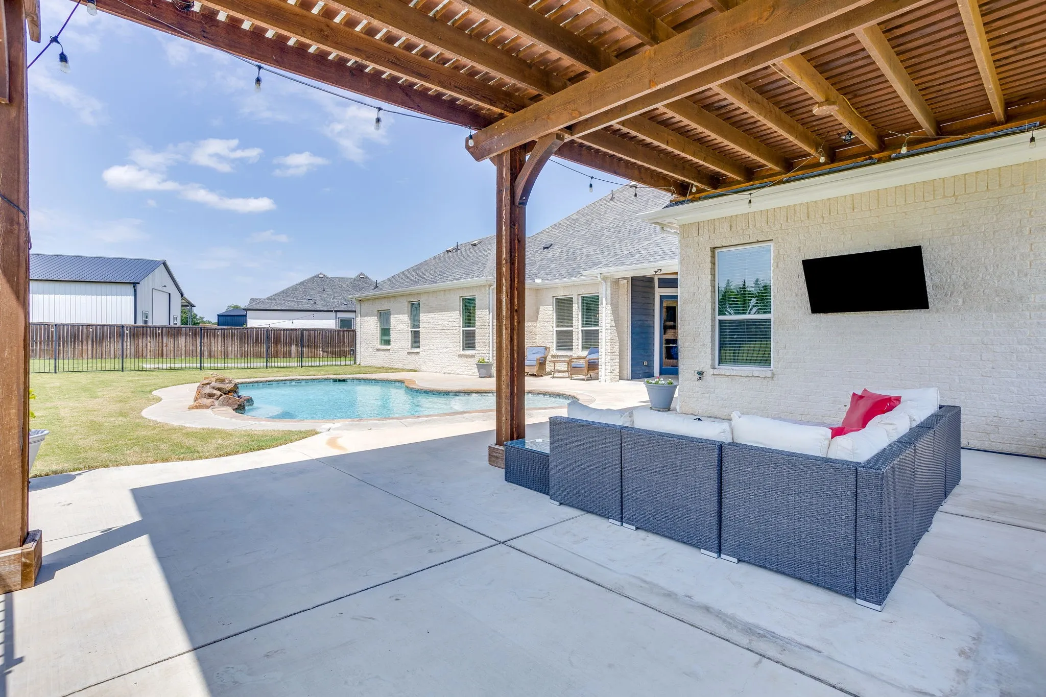Outdoor living area featuring a custom wood pergola