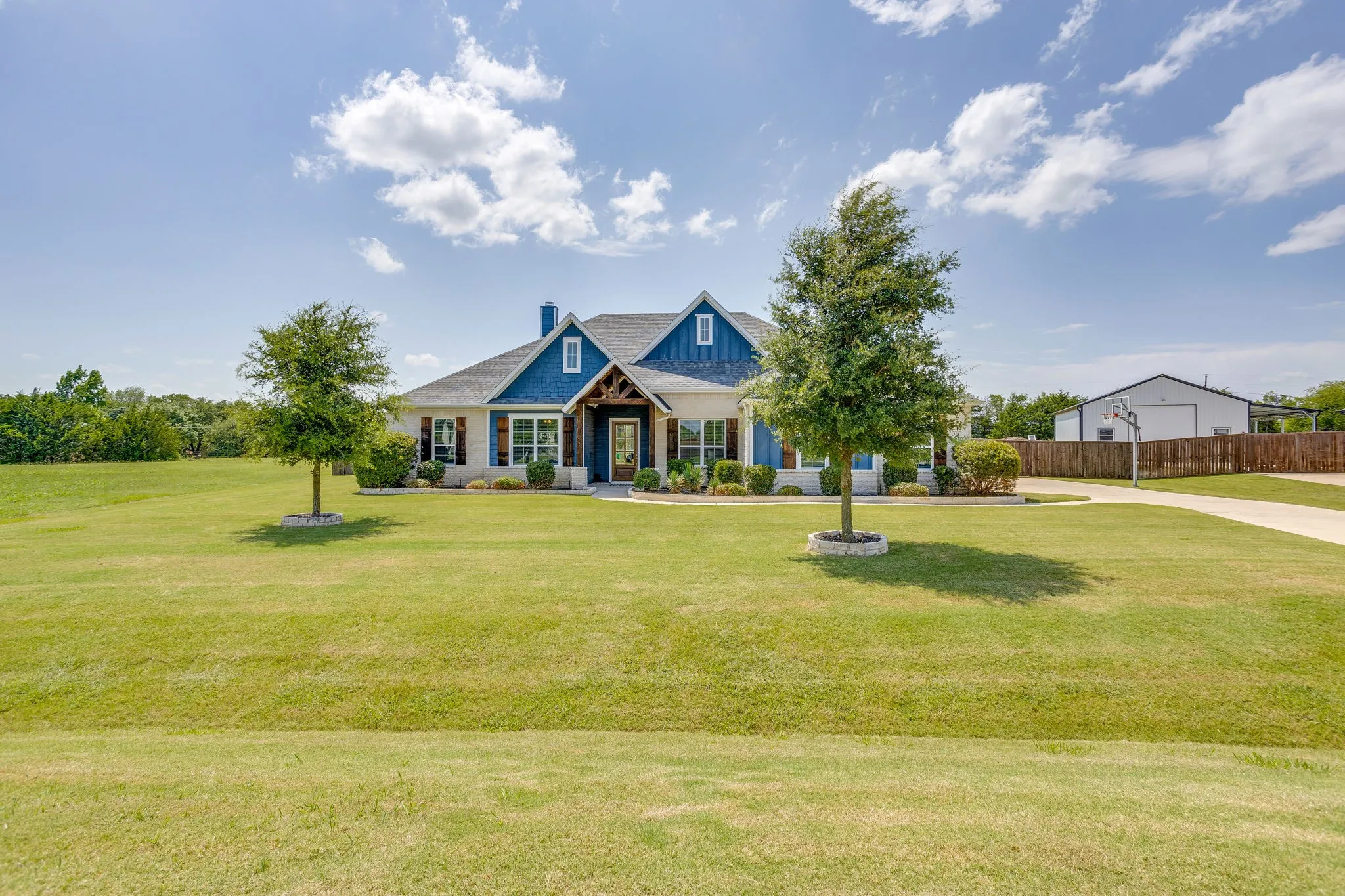 Expansive green lawn with mature trees
