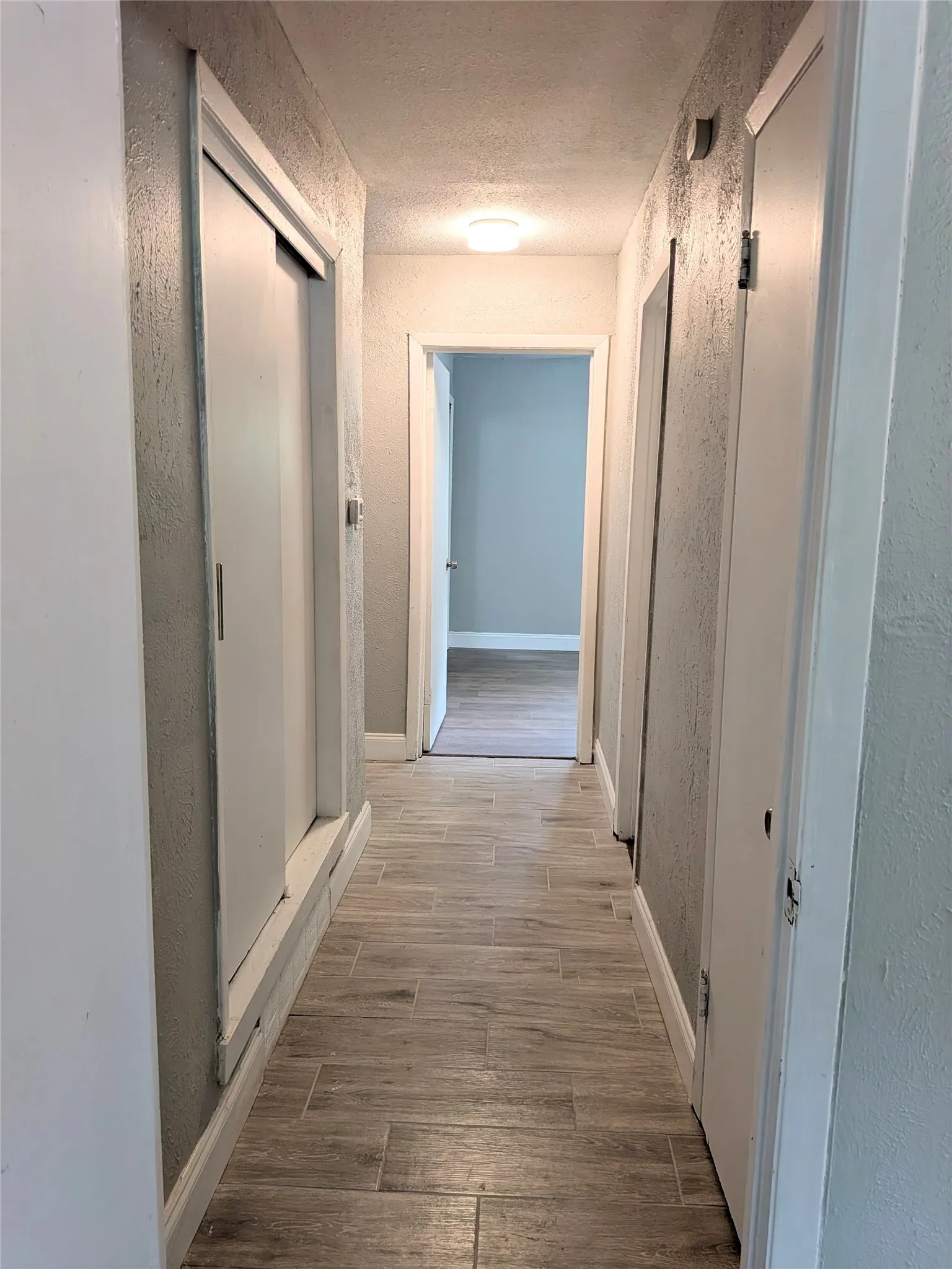Hallway with wood-look tile flooring