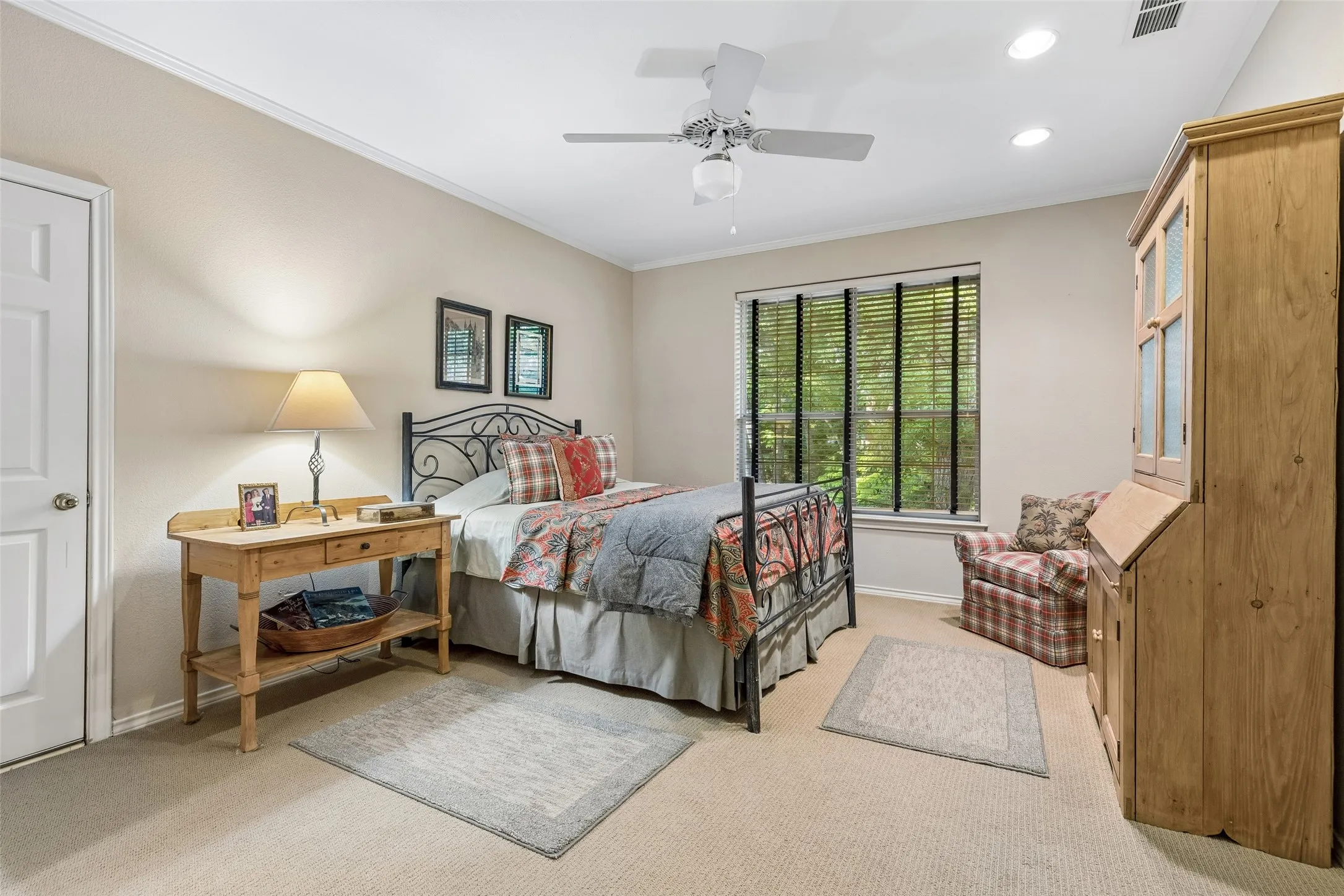 Upstairs bedrooms are spacious. Room for a reading area and a window with views to the foliage outside.  Lighted ceiling fan as well as recessed lighting.