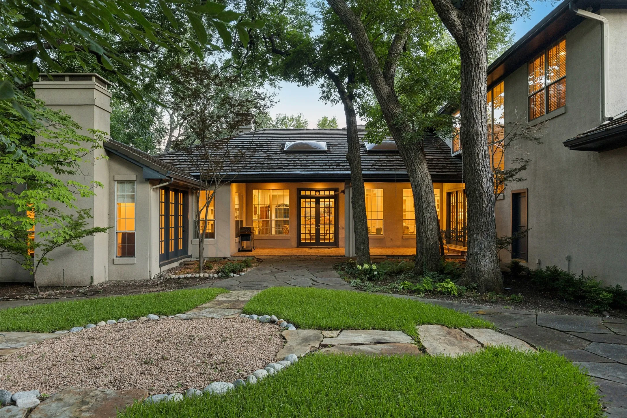 Exquisite rear patio with entrance from 3 sets of French Doors (Study on left, Great Room in center & Kitchen to the right). Perfect place to grill, relax or just enjoy a good book.