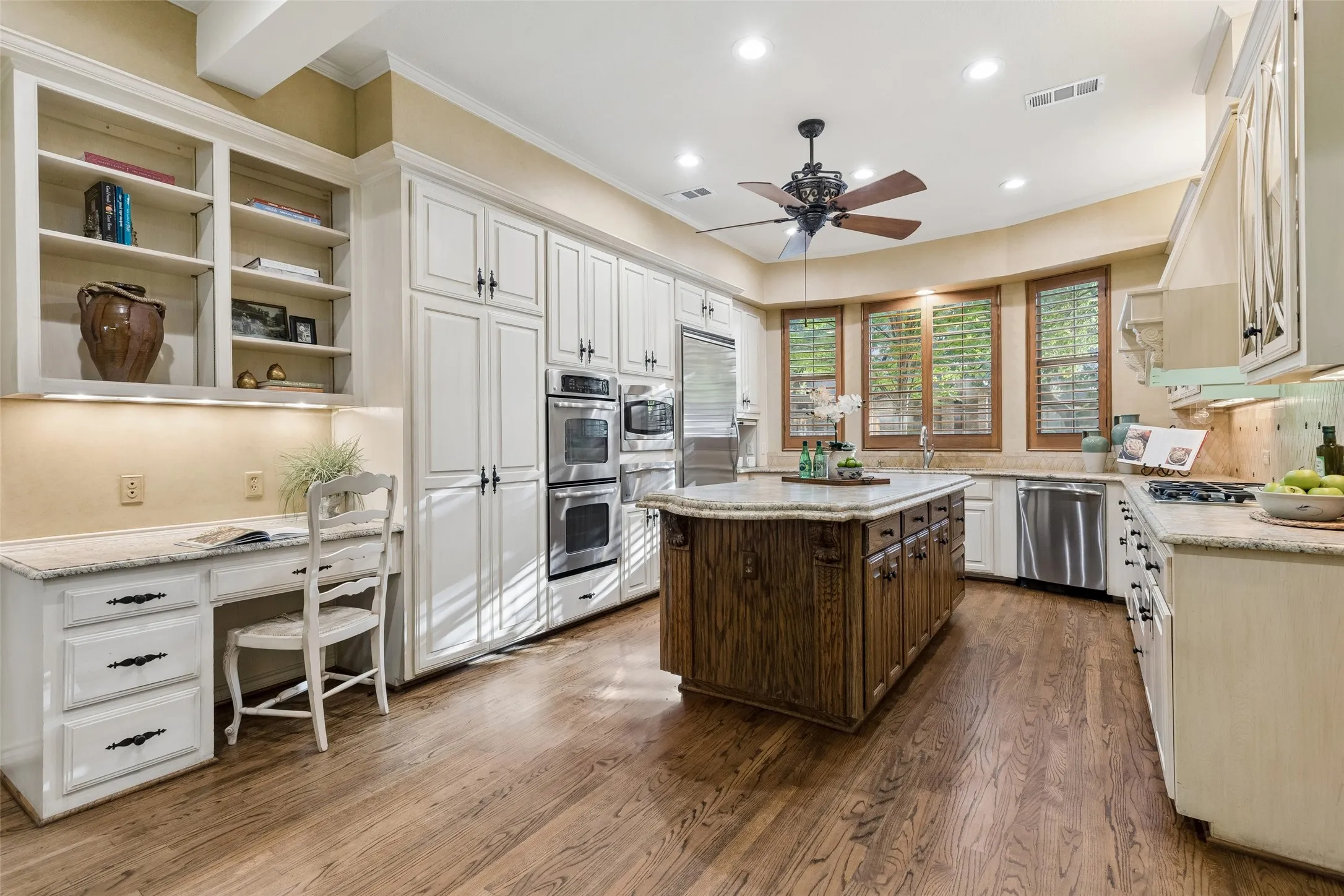 Country-French designed Kitchen features Granite topped Island with beadboard stained wood.  Both sides of Island provide storage with pull-out shelves.  Stainless appliances include double ovens, microwave and warming drawer. PLUS a desk with shelves for cookbooks or your choice.