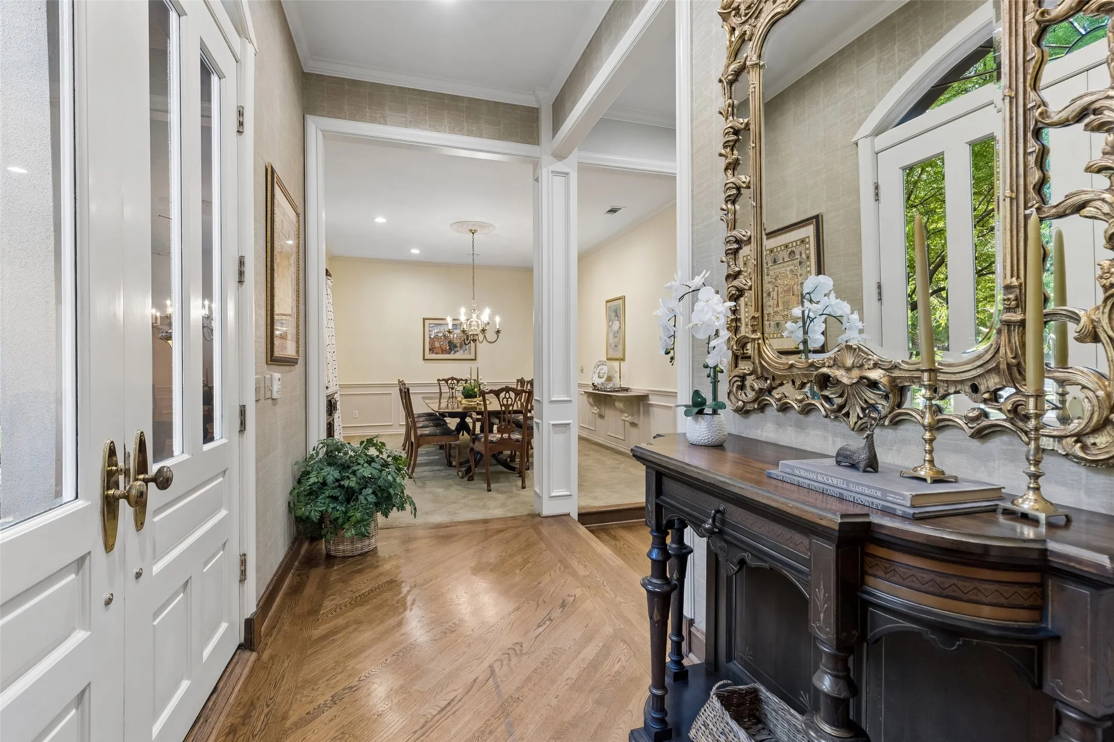 Enter through  9-10 ft high beautiful double doors into the foyer with view of dining room to the left and living den straight ahead.