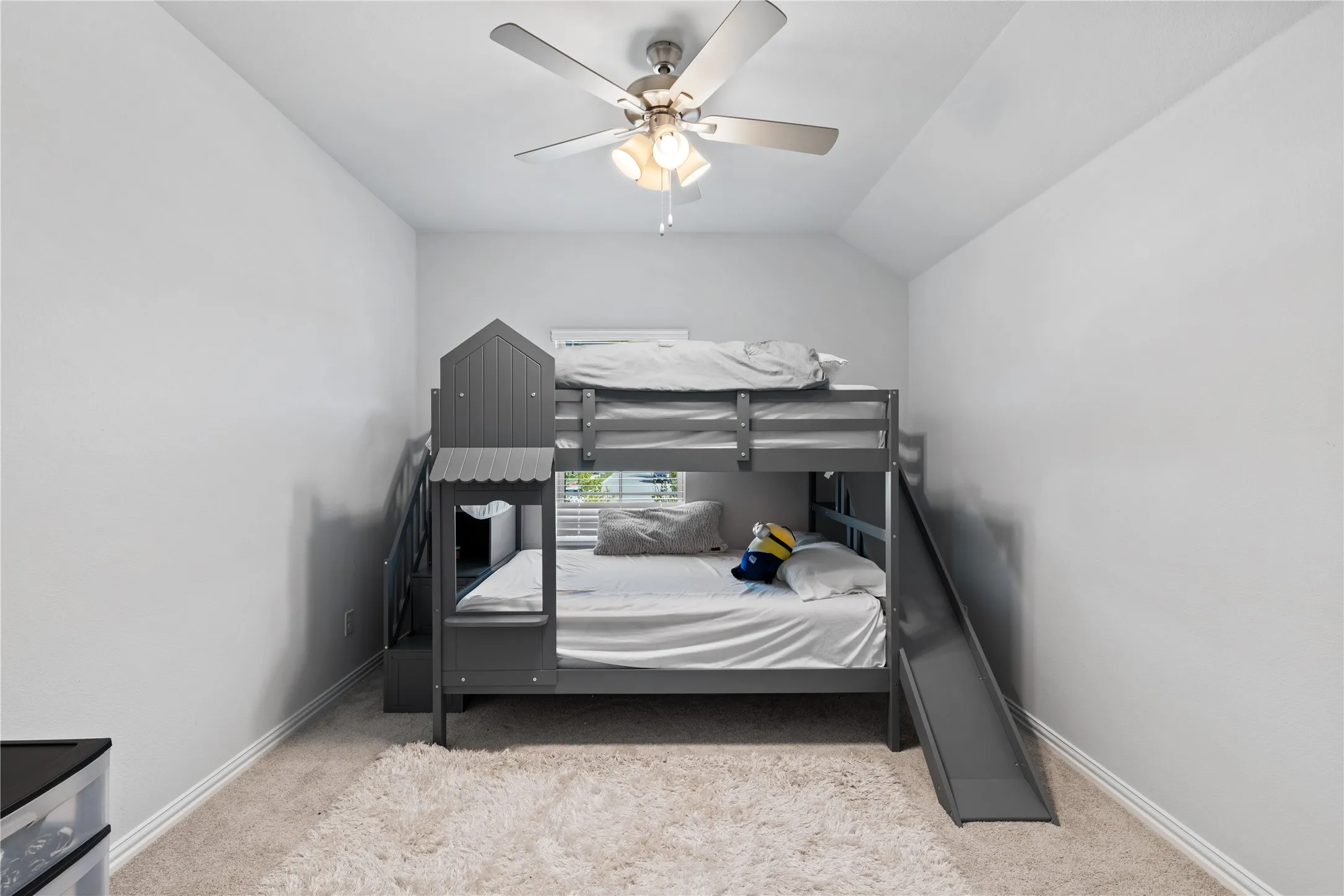 Spacious secondary bedroom featuring vaulted ceilings, plush carpet, generous closet space, and abundant natural light—perfect for a growing family, guests, or a private home office.