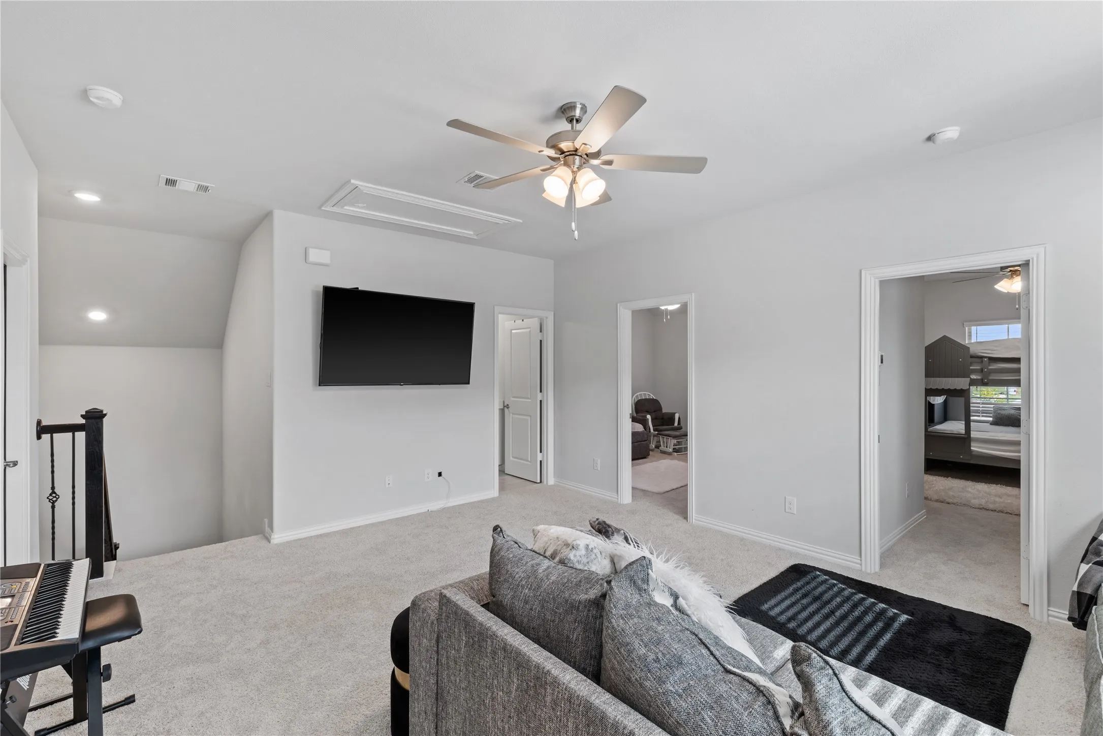 Oversized upstairs game room offering endless possibilities for a second living area, playroom, home office, homeschool space, or media lounge with convenient access to all upstairs bedrooms.