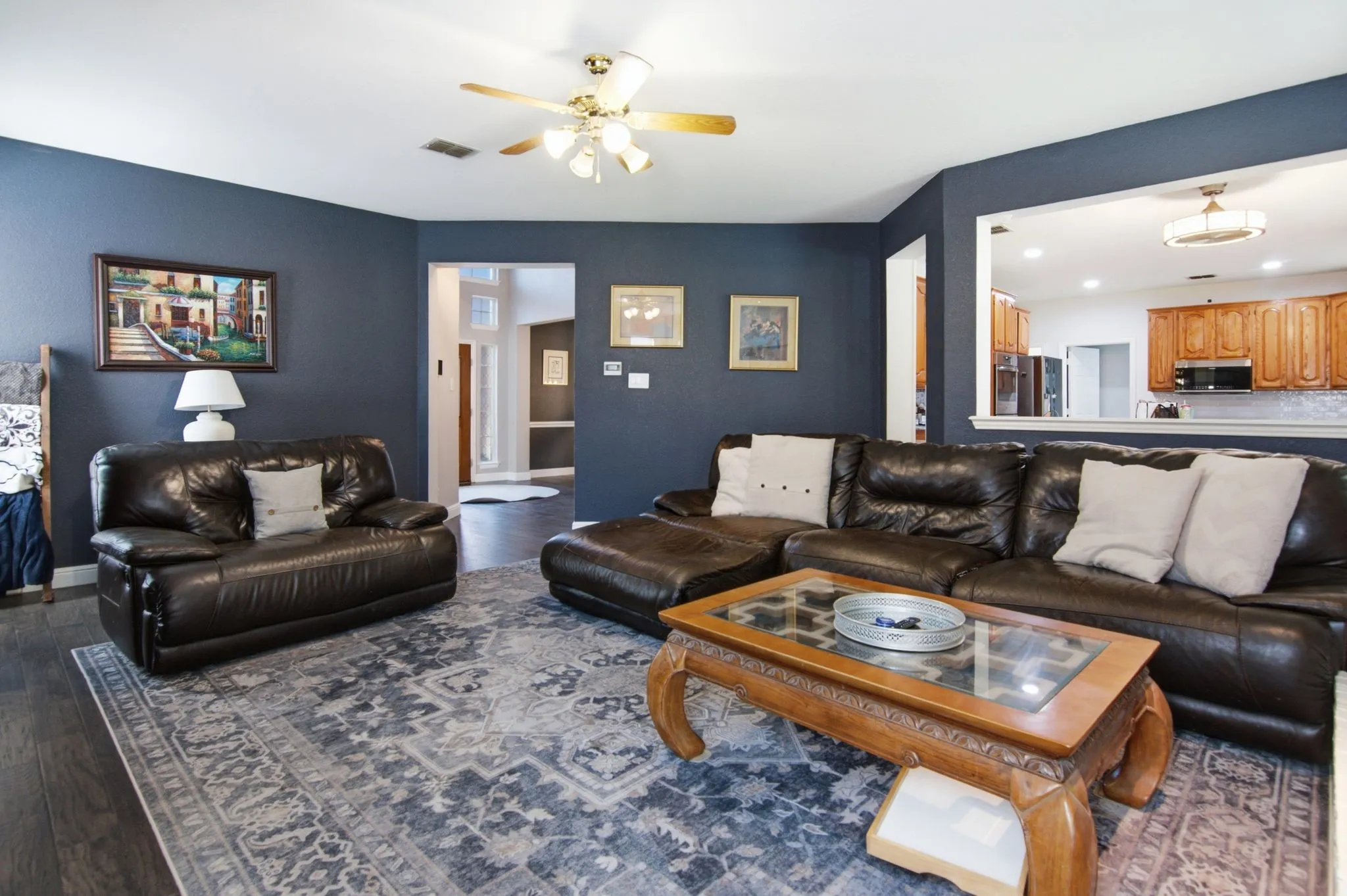 Family room features an architectural pass-through to a kitchen.