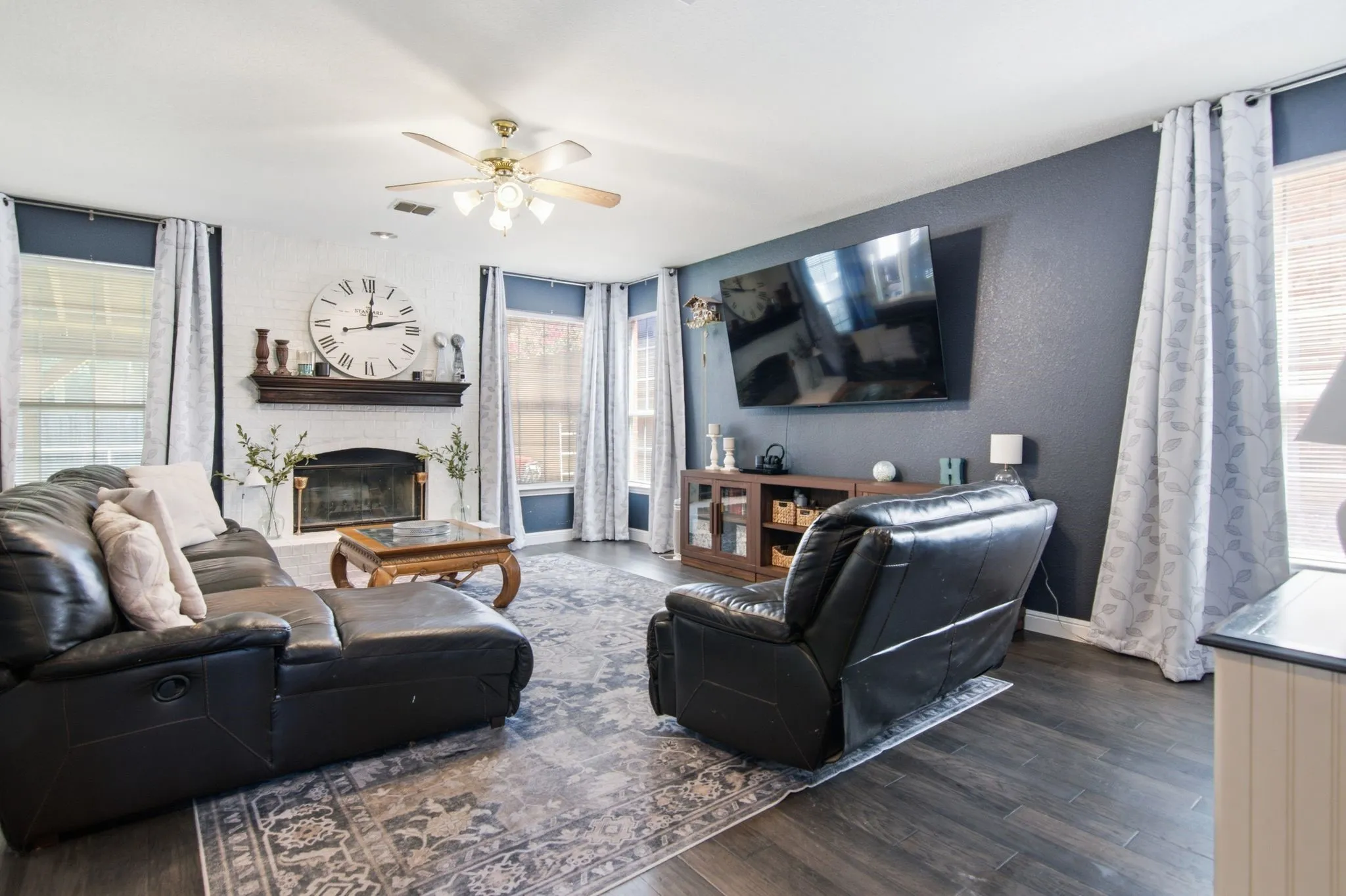 The family room boasts wood-finish flooring, abundant natural light, and a cozy fireplace, offering plenty of space to enjoy life your way.