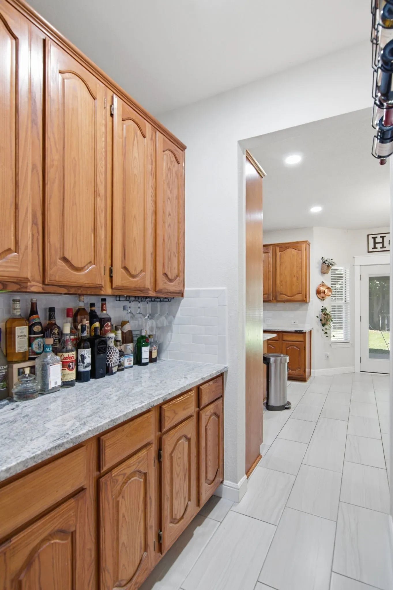 A separate bar area with built-in cabinets offers plenty of extra storage.