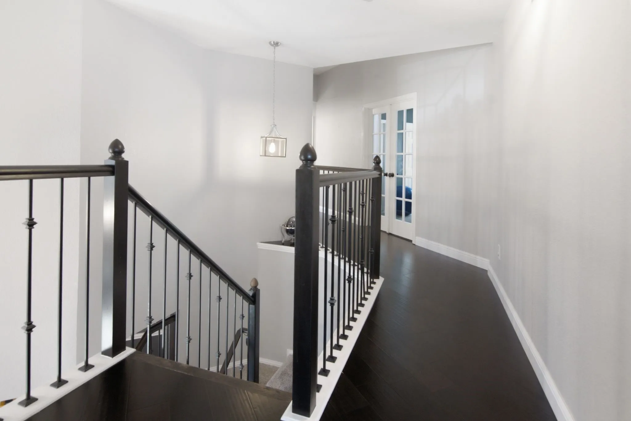 A hallway leads to three secondary bedrooms, a full bathroom, and a versatile game room, den, or flex space with double doors.