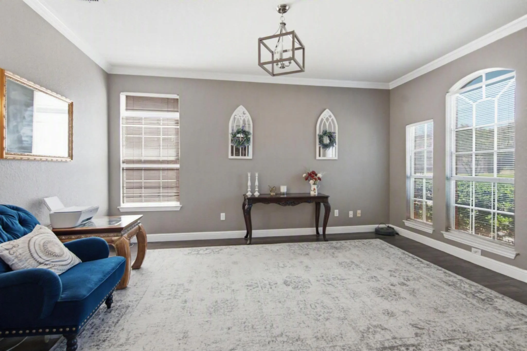 Living room space featuring added French double doors, currently serving as a home office.