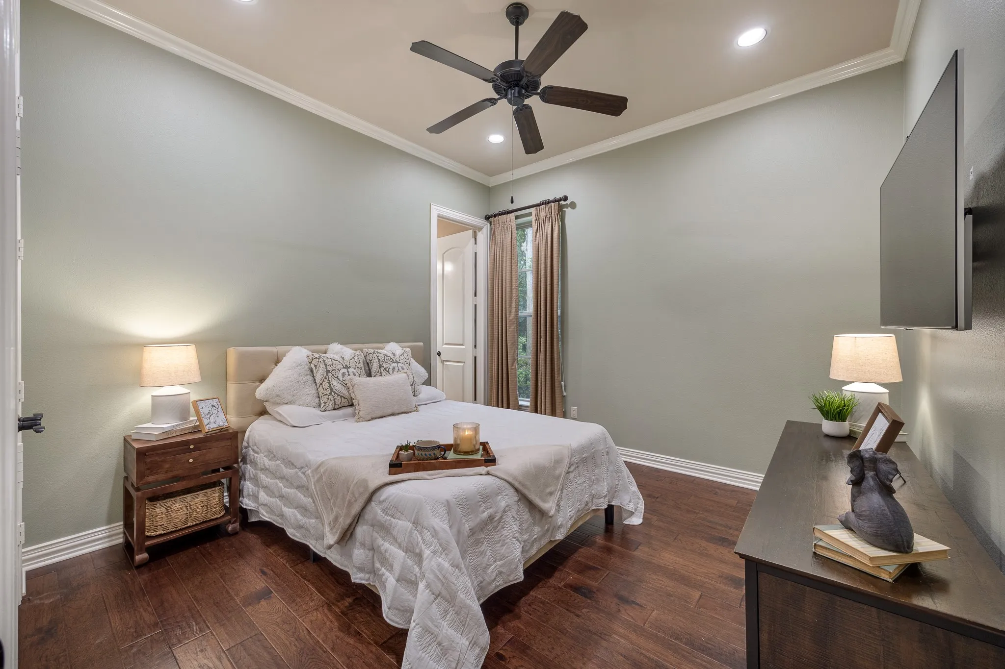 Bedroom featuring a ceiling fan with irecessed ceiling lights, crown molding, and wood flooring