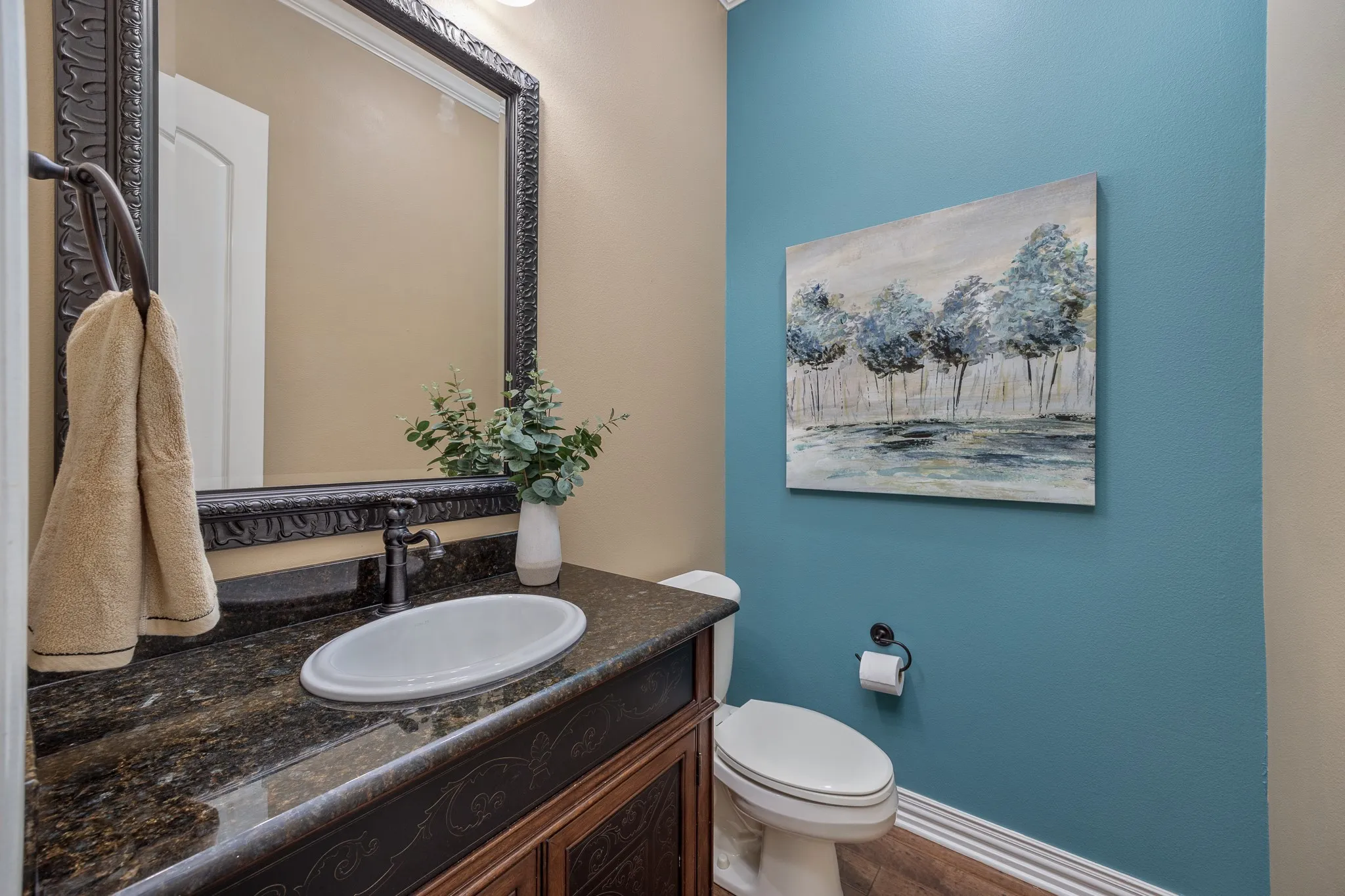 Powder room featuring granite countertop