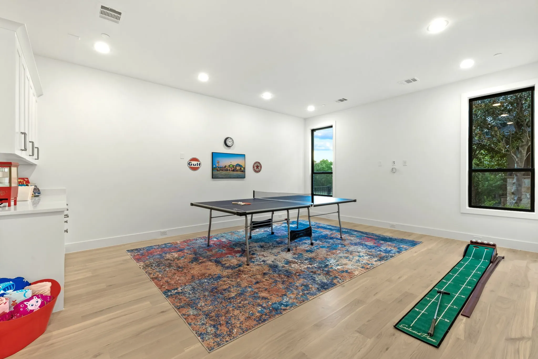 Downstairs game room with cabinetry