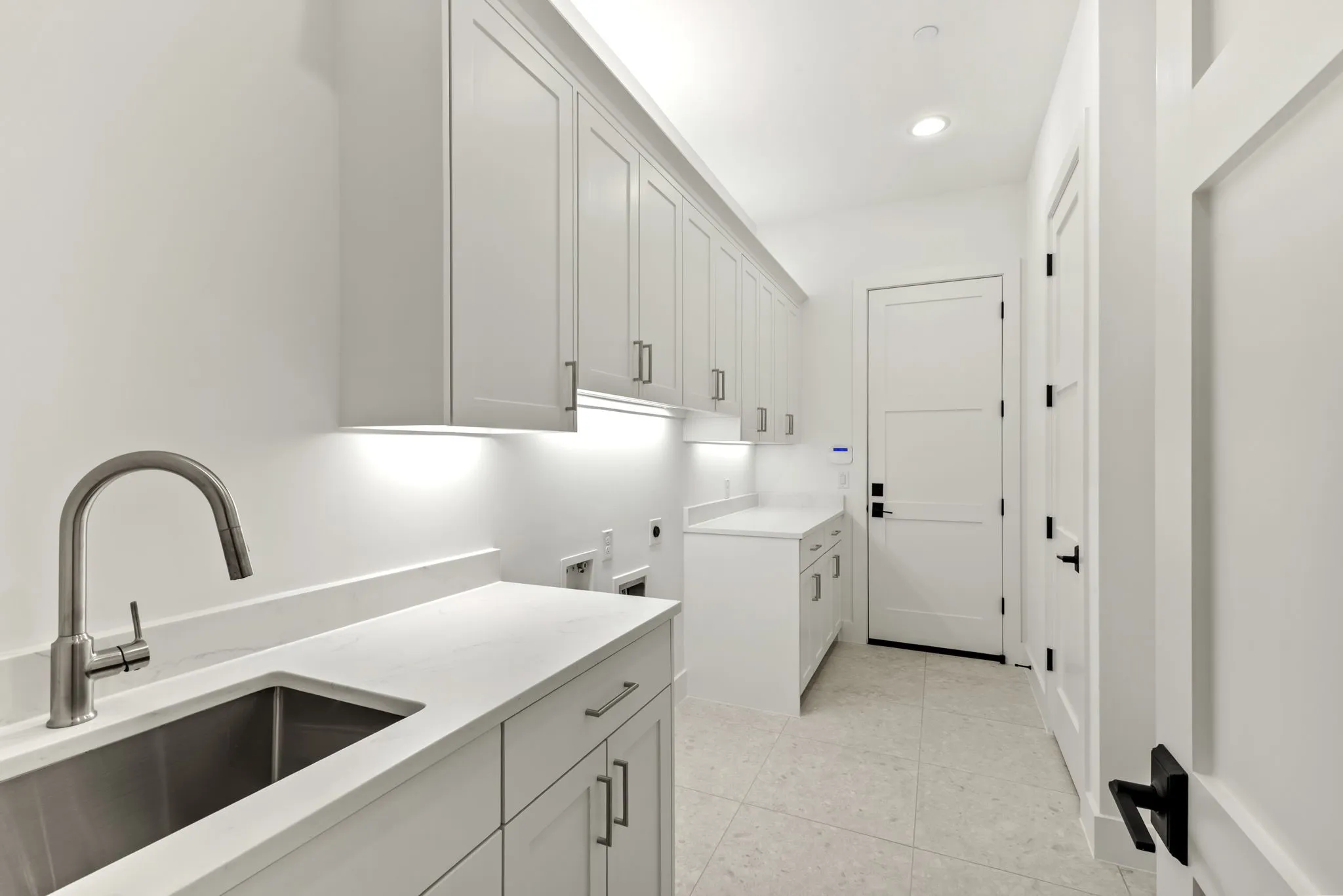 Sink and second pantry in laundry as well as mudroom with hooks