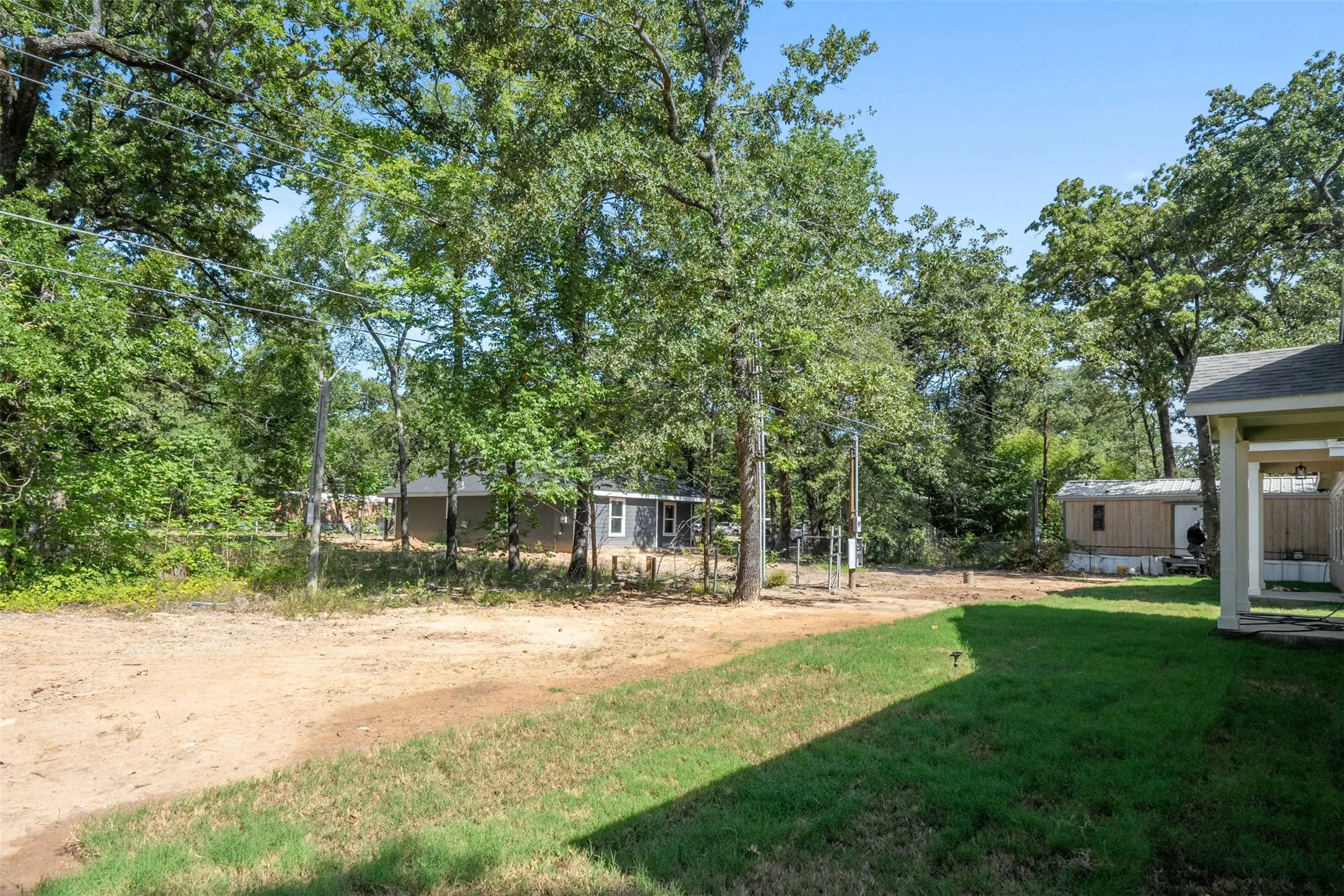 Expansive green lawn with a dirt path