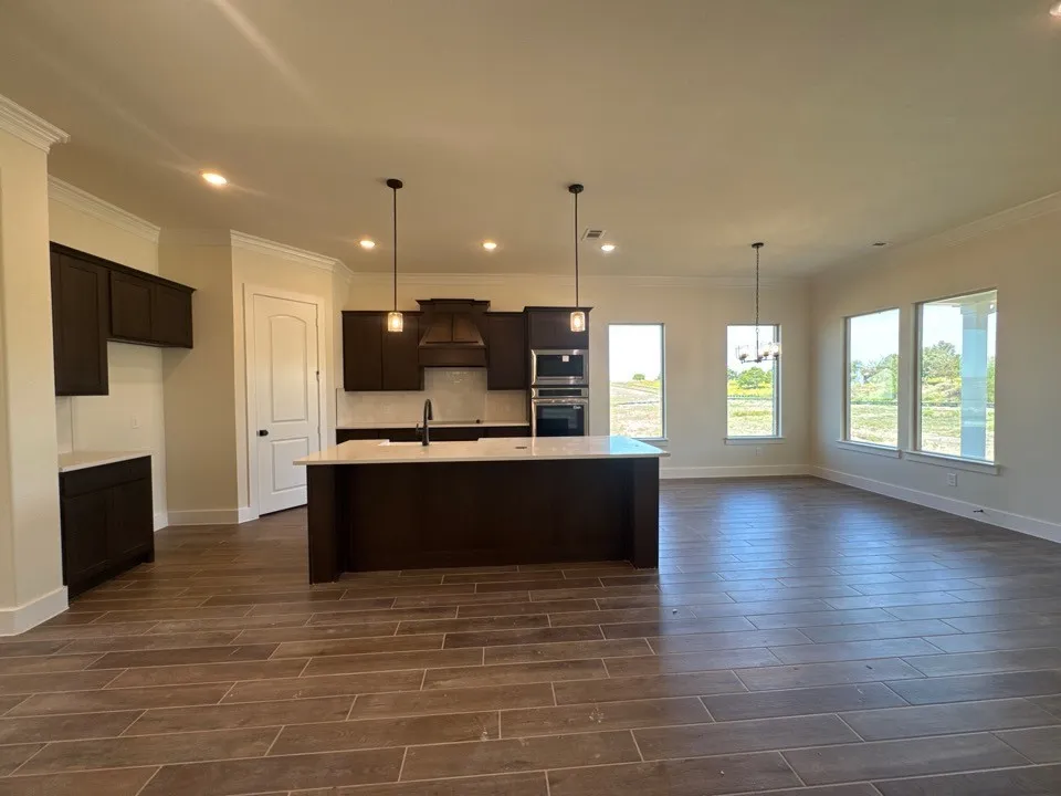Open-concept living space with wood-finish flooring
