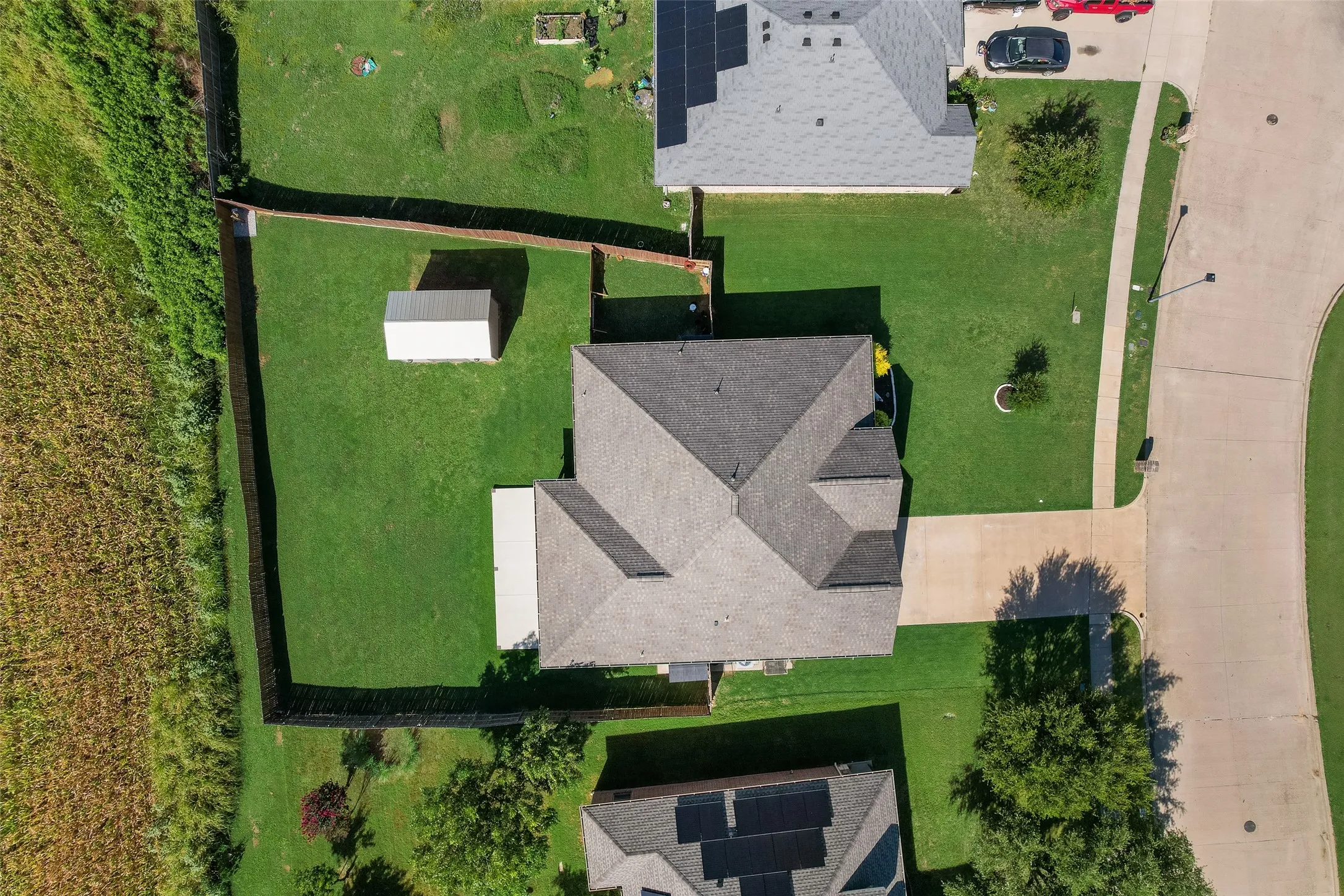 Expansive property featuring a sizable backyard, mature landscaping, and a secure privacy fence