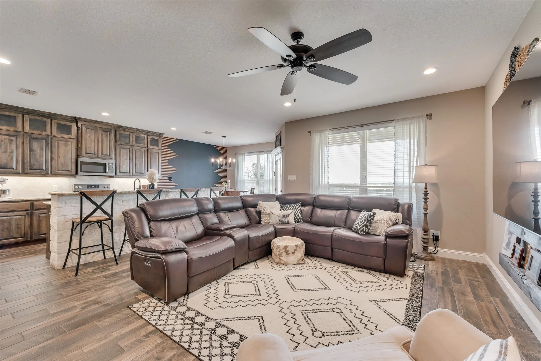 Open-concept living space featuring wood-finish flooring and recessed lighting