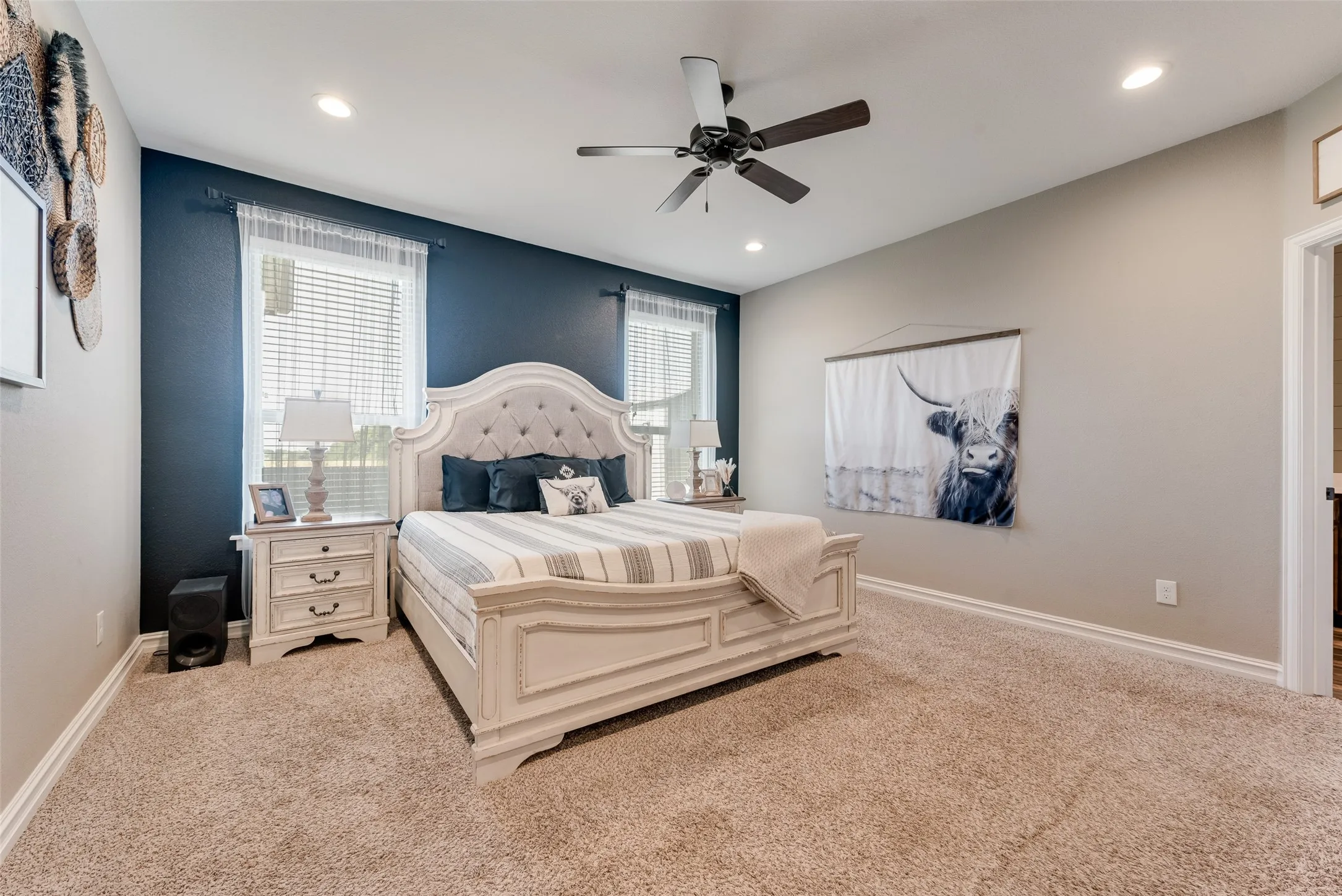 Carpeted bedroom featuring a ceiling fan, recessed lighting, and dual windows with blinds and sheer curtains