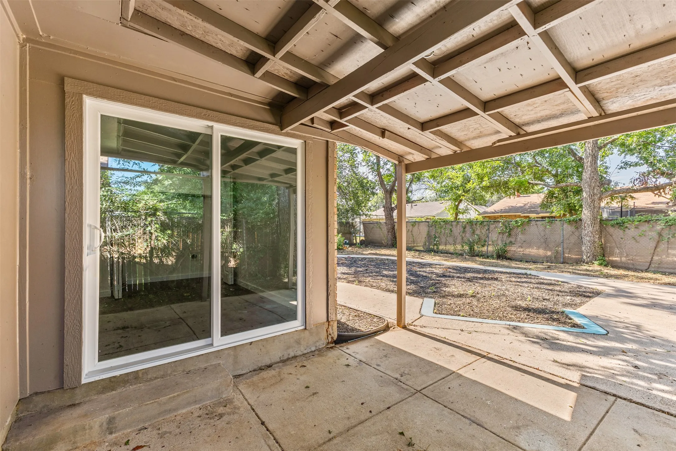 Covered patio featuring a concrete slab and exposed wood beam ceiling